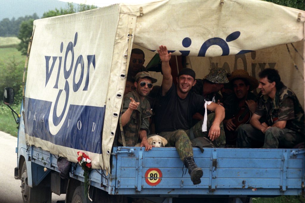 Croatian volunteer waves his hand on his way, together with comrades, from the frontline, Slunj, Croatia, 11 August 1995. EPA/ATTILA KISBENEDEK