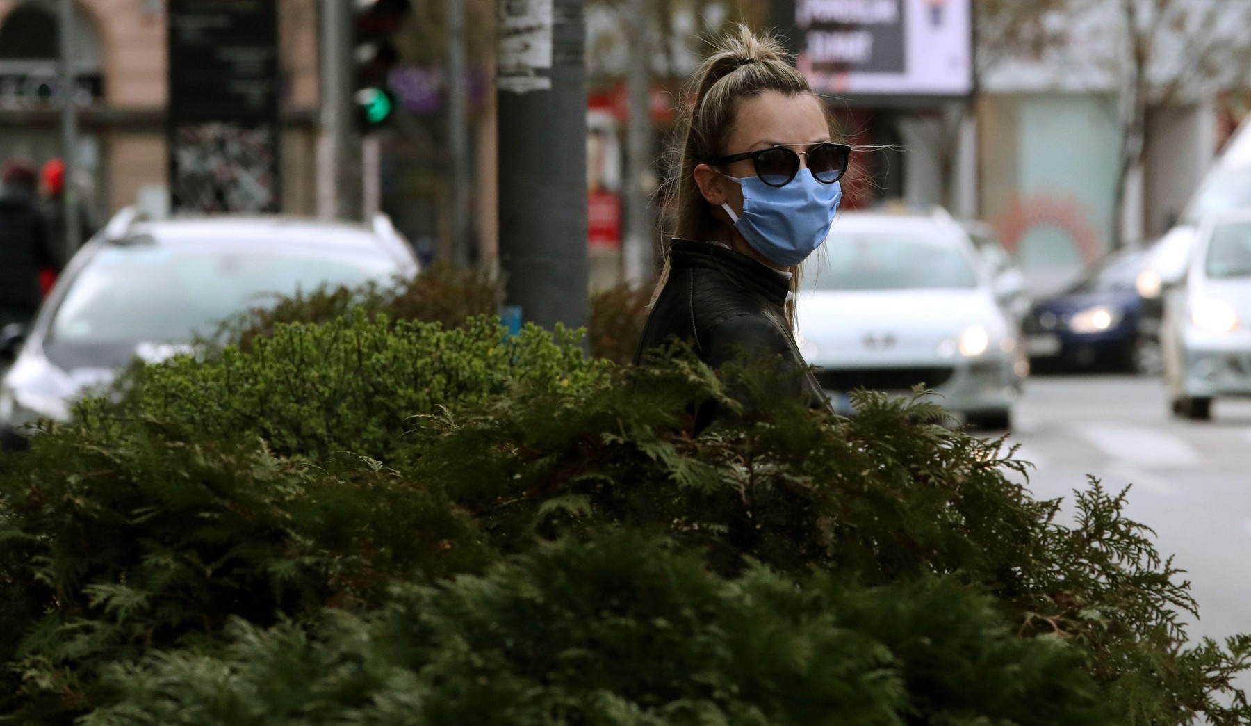 Belgrade, Serbia. 23th March 2020.Person wearing a protective face mask passes the street in downtown Belgrade, Serbia, during the ongoing pandemic of the COVID-19 disease caused by the SARS-CoV-2 coronavirus.