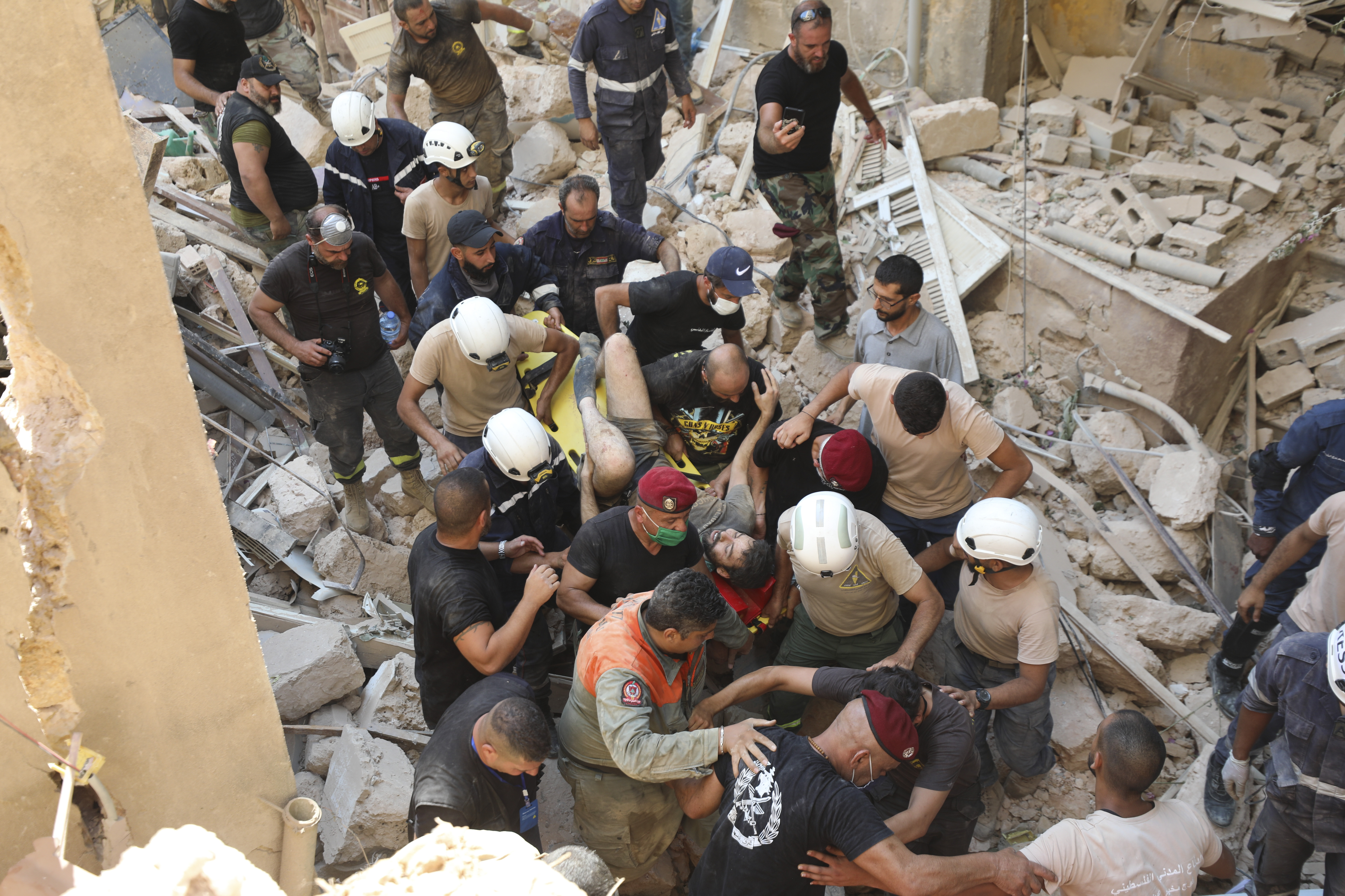 A survivor is taken out of the rubble after a massive explosion in Beirut, Lebanon, Wednesday, Aug. 5, 2020. (AP Photo/Hassan Ammar)