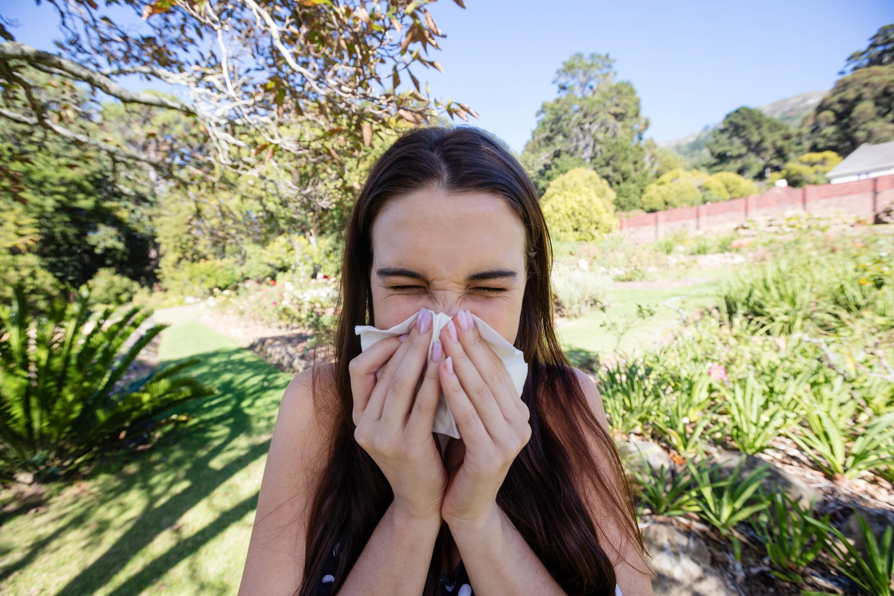 Woman blowing nose with tissue paper in park,Image: 326903433, License: Rights-managed, Restrictions: , Model Release: yes, Credit line: - / Wavebreak / Profimedia
