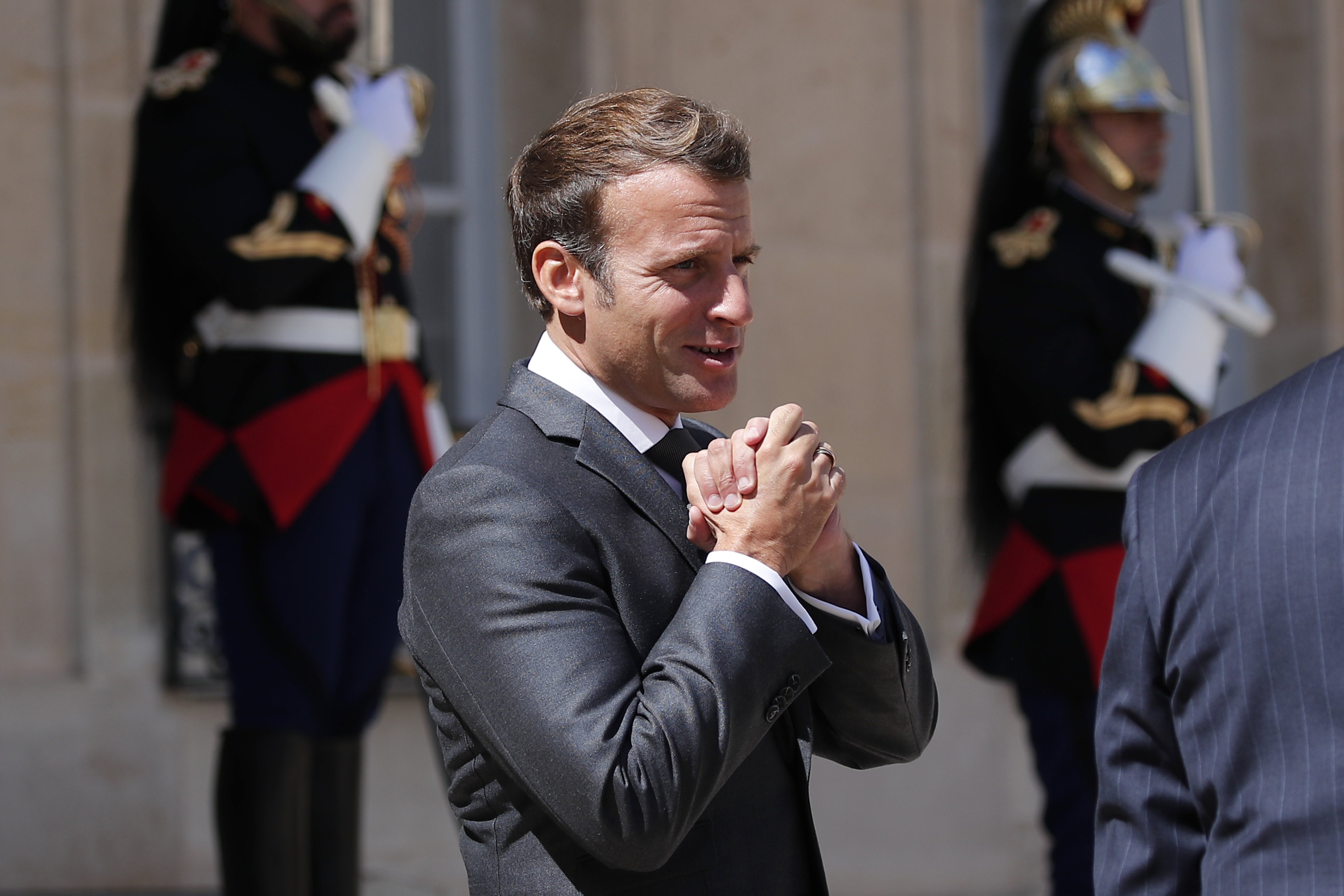 French President Emmanuel Macron salutes as he accompanies Cypriot President Nicos Anastasiades after their meeting at the Elysee Palace, in Paris, Thursday, July 23, 2020. (AP Photo/Francois Mori)