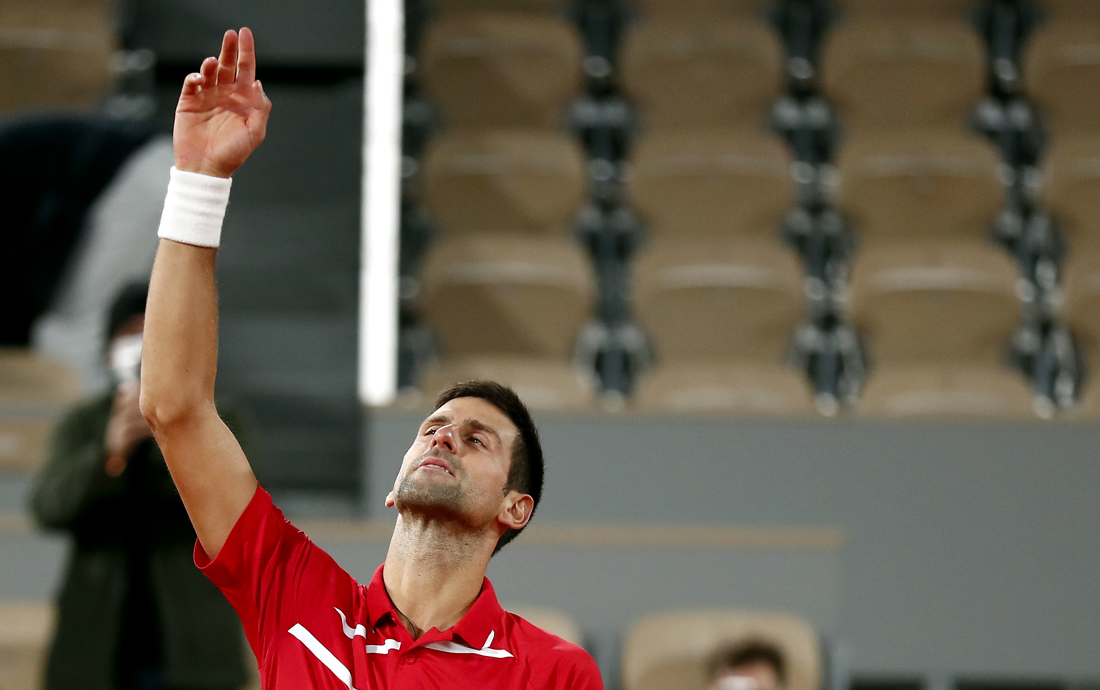epa08733102 Novak Djokovic of Serbia reacts after winning against Stefanos Tsitsipas of Greece in their men?s semi final match during the French Open tennis tournament at Roland ?Garros in Paris, France, 09 October 2020.  EPA-EFE/IAN LANGSDON