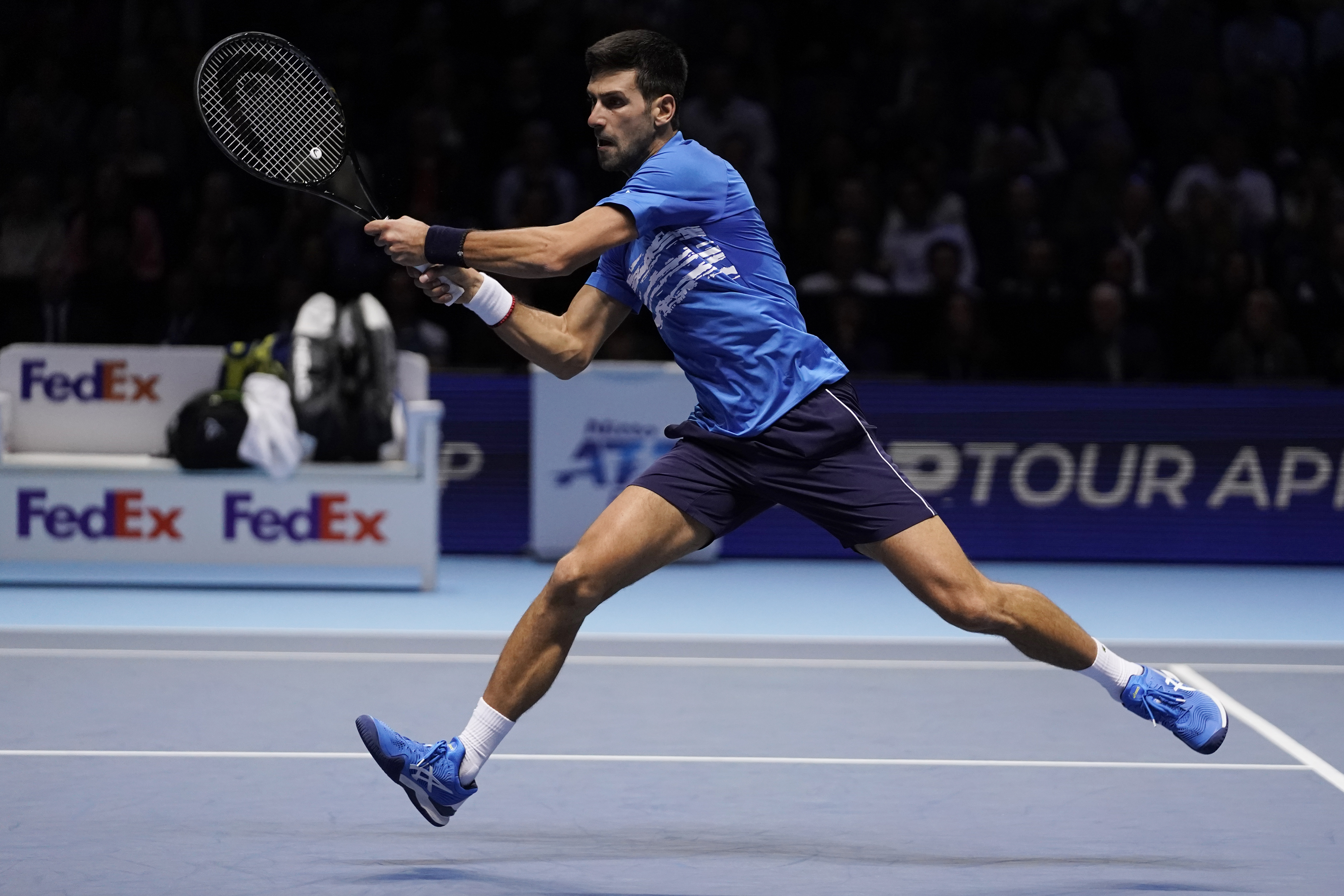 epa07997024 Novak Djokovic of Serbia returns to Roger Federer of Switzerland during his round robin match against at the ATP World Tour Finals tennis tournament in London, Britain, 14 November 2019.  EPA-EFE/WILL OLIVER