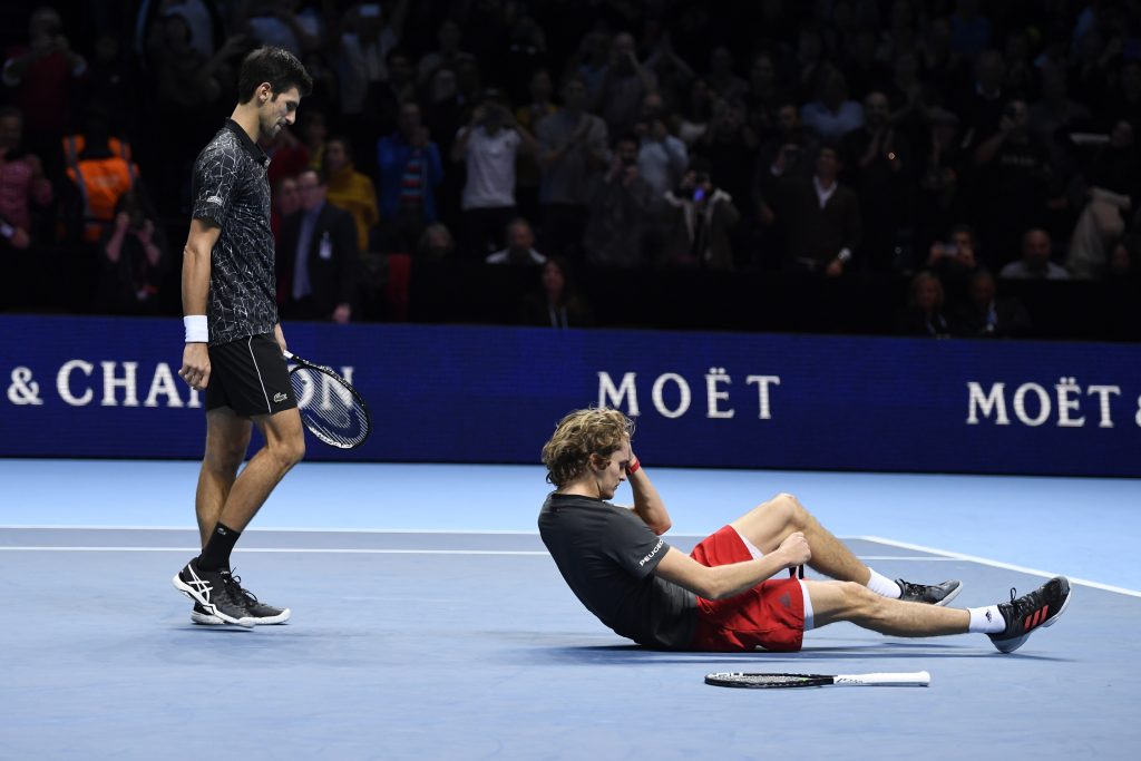 epa07175888 Germany's Alexander Zverev (R) reacts after beating Serbia's Novak Djokovic (L) in their final match at the ATP World Tour Finals tennis tournament  at the O2 Arena in London, Britain, 18 November 2018.  EPA-EFE/WILL OLIVER