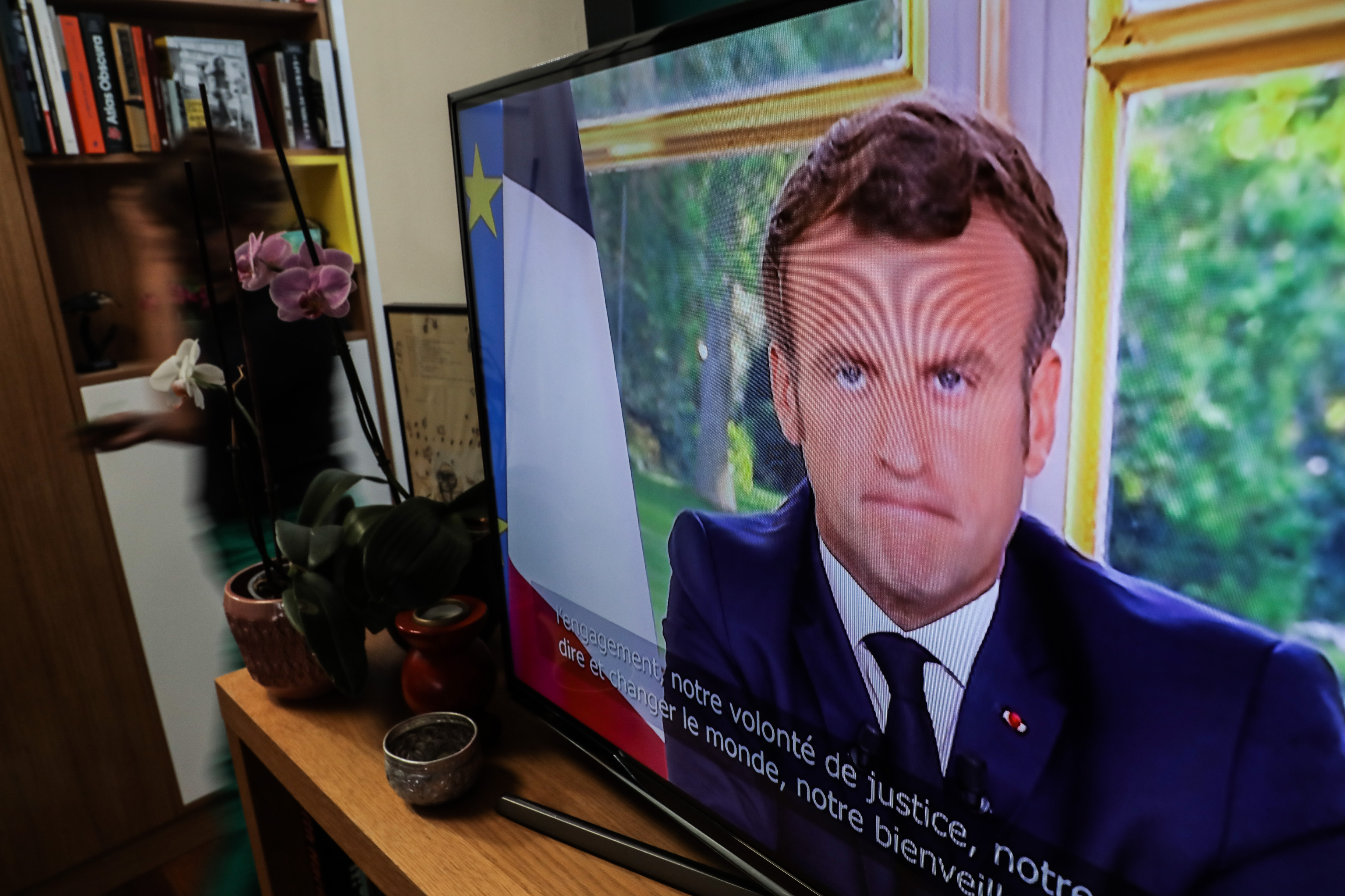 epa08485497 A TV screen shows French President Emmanuel Macron addressing the nation from the Elysee Palace in Bois-Colombes, near Paris, France, 14 June 2020.  EPA-EFE/CHRISTOPHE PETIT TESSON