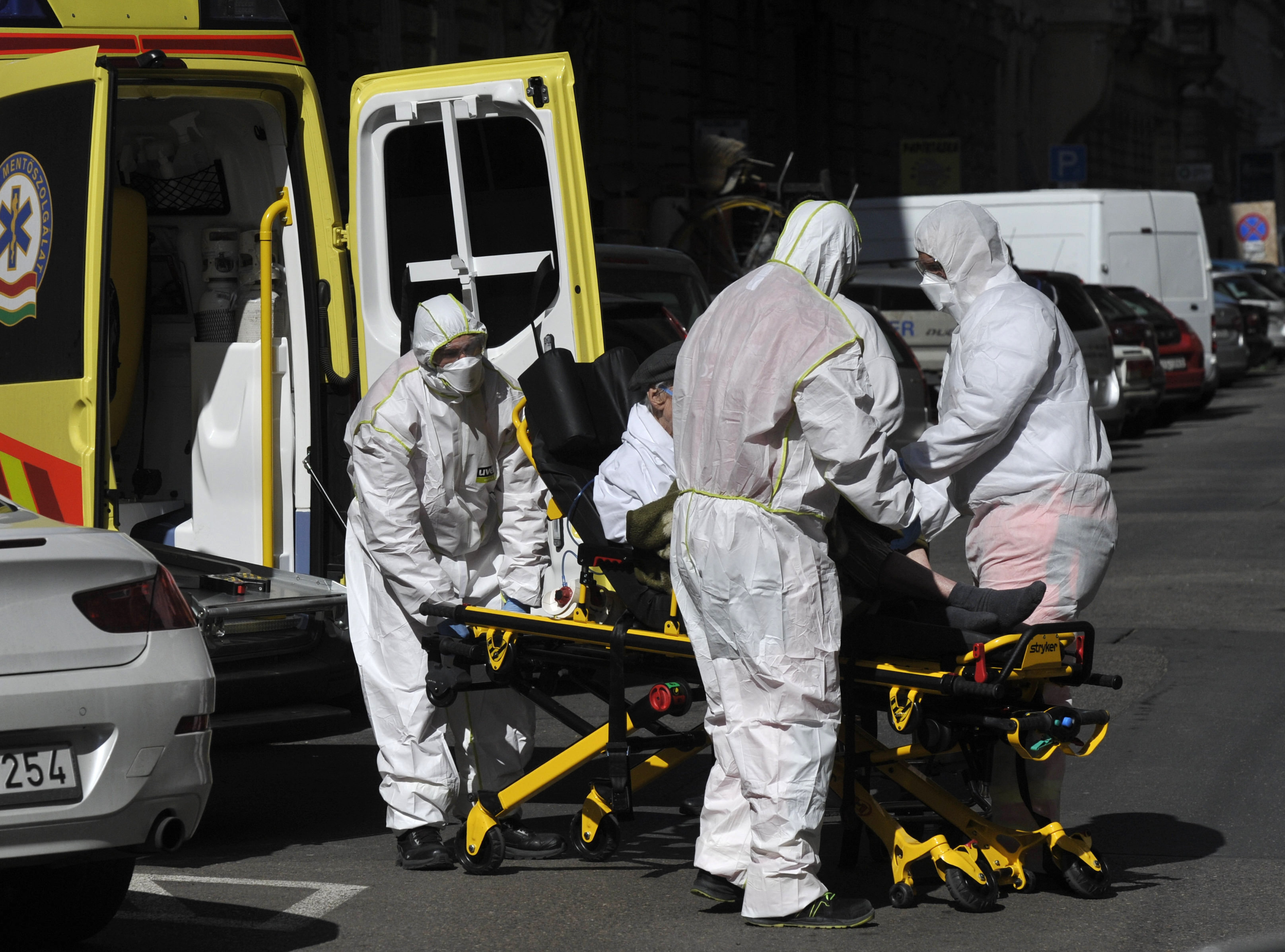 Health workers transport a patient on a stretcher upon arrival at the Szent Laszlo hospital in Budapest, Hungary, Tuesday, March 24, 2020. The hospital is the centre care unit of the coronavirus-infected people. (Zoltan Mihadak/MTI via AP)