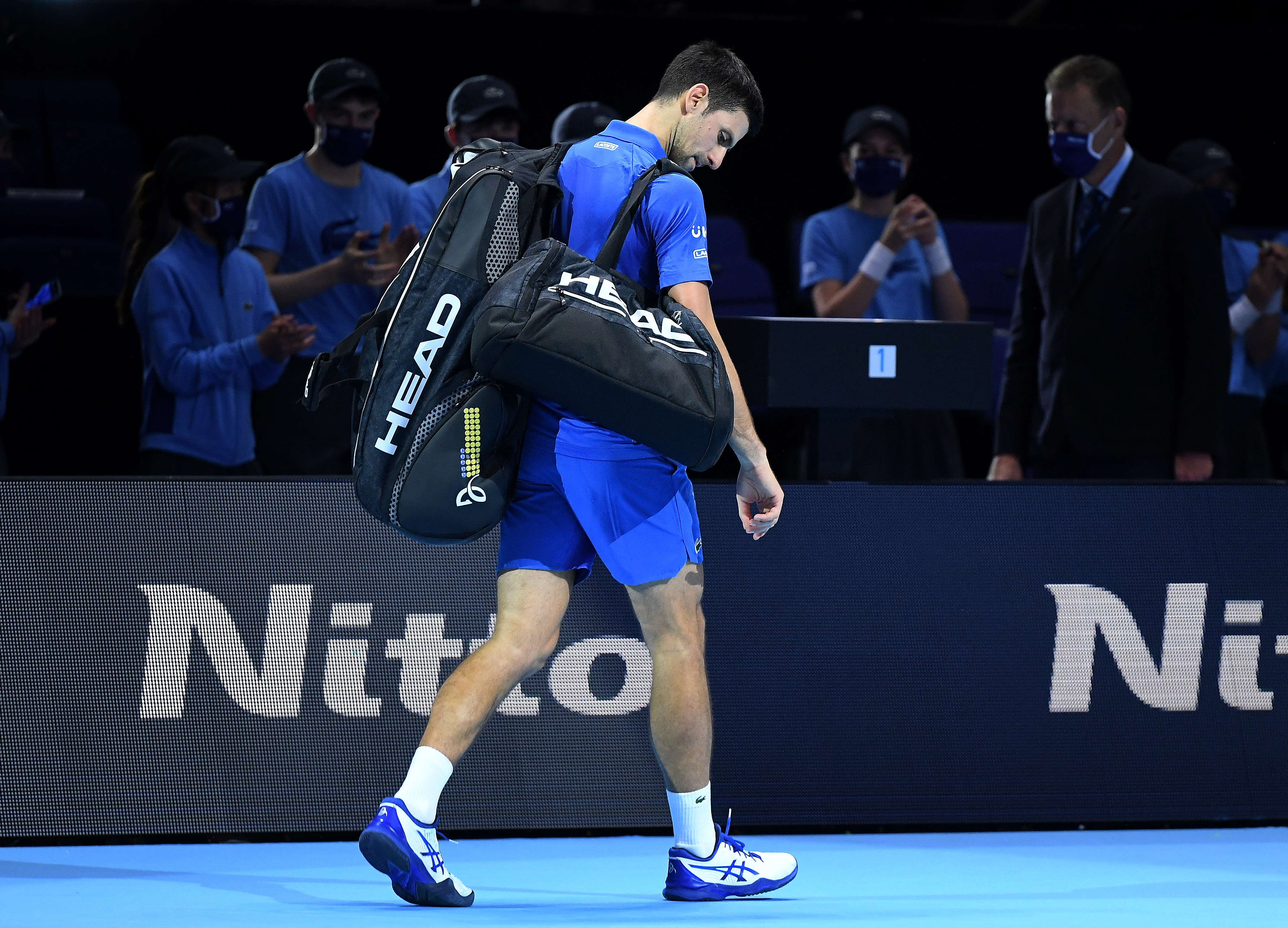 epa08834049 Novak Djokovic of Serbia leaves the pitch after losing against Dominic Thiem of Austria at the end of their semi final match at the ATP World Tour Finals tennis tournament in London, Britain, 21 November 2020.  EPA-EFE/ANDY RAIN