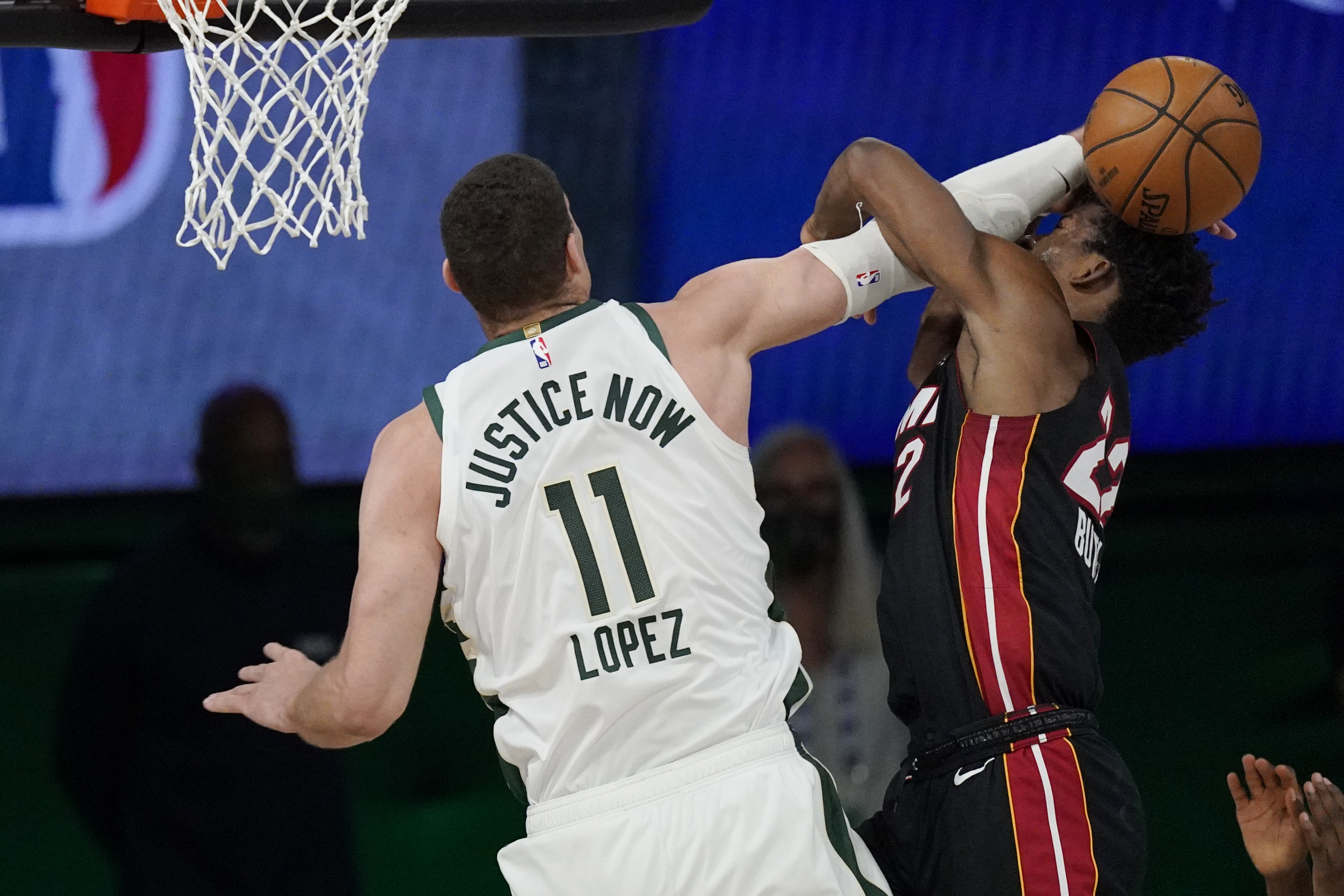 Milwaukee Bucks' Brook Lopez (11) fouls Miami Heat's Jimmy Butler (22) in the second half of an NBA conference semifinal playoff basketball game Tuesday, Sept. 8, 2020 in Lake Buena Vista, Fla. (AP Photo/Mark J. Terrill)