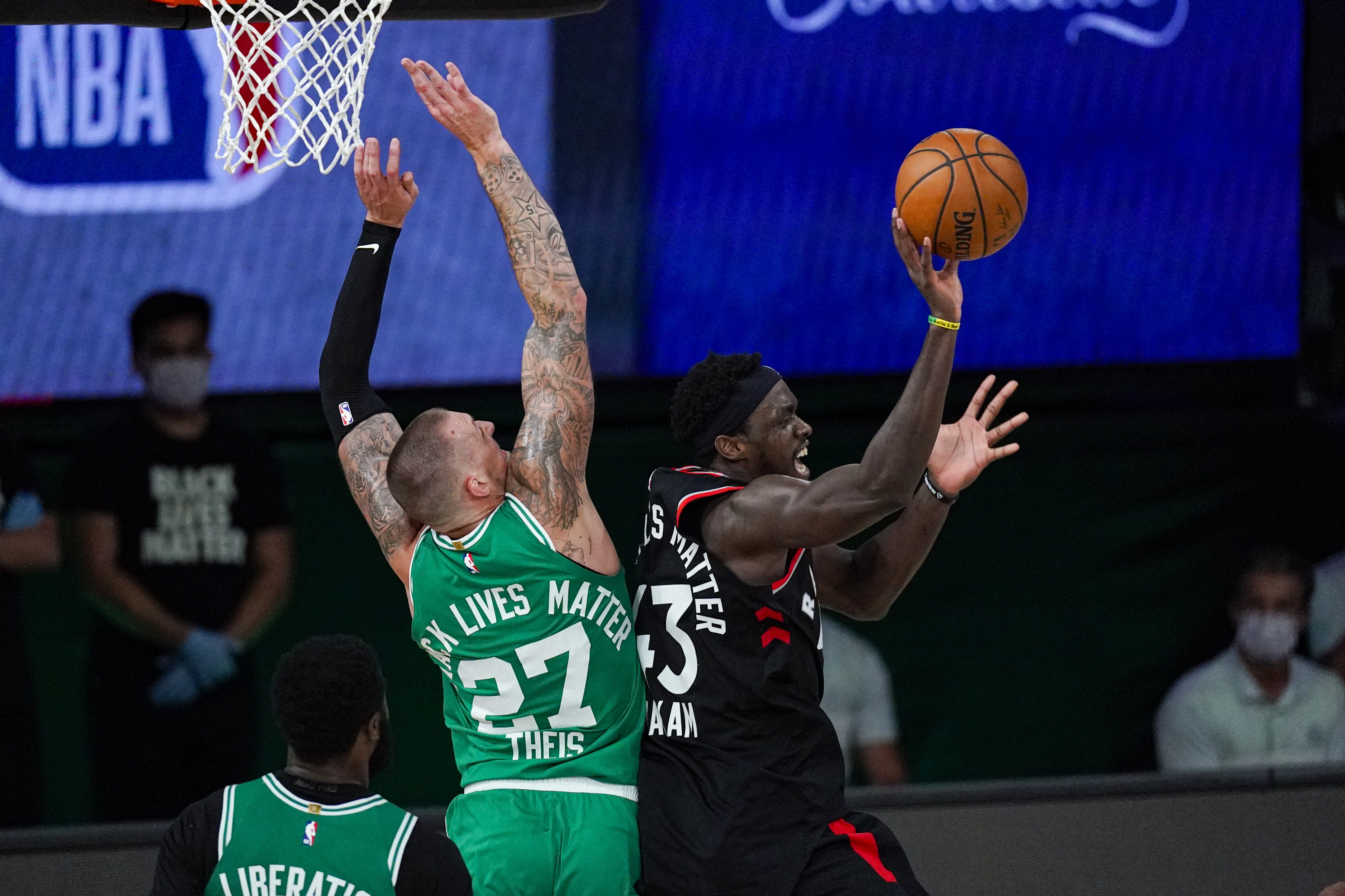 Toronto Raptors forward Pascal Siakam (43) passes out from Boston Celtics center Daniel Theis (27) during the second half of an NBA conference semifinal playoff basketball game Wednesday, Sept. 9, 2020, in Lake Buena Vista, Fla. (AP Photo/Mark J. Terrill)