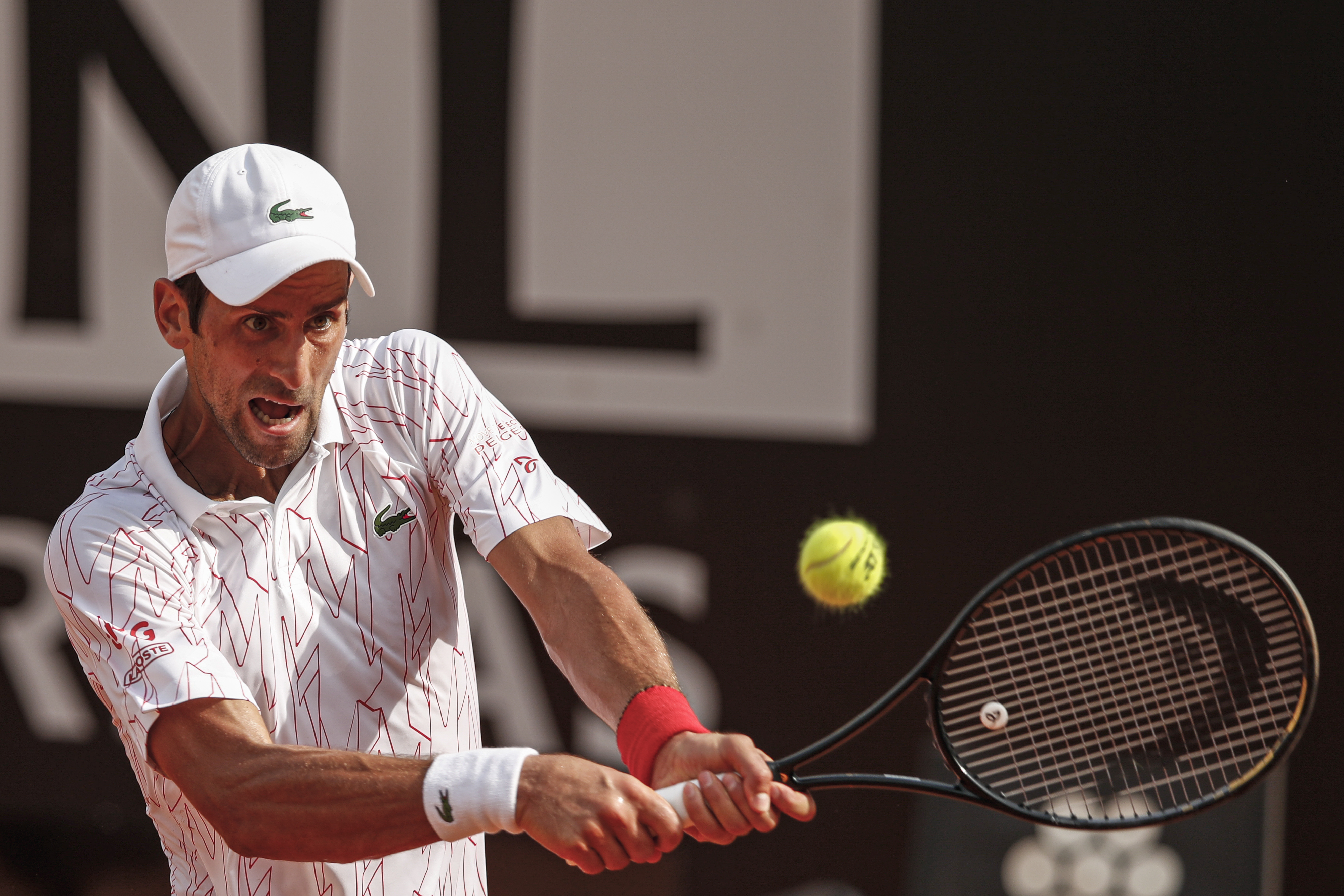 epa08681062 Novak Djokovic of Serbia in action during his men's singles quarter-finals round match against Dominik Koepfer of Geermany at the Italian Open tennis tournament in Rome, Italy, 19 September 2020.  EPA-EFE/Clive Brunskill / POOL