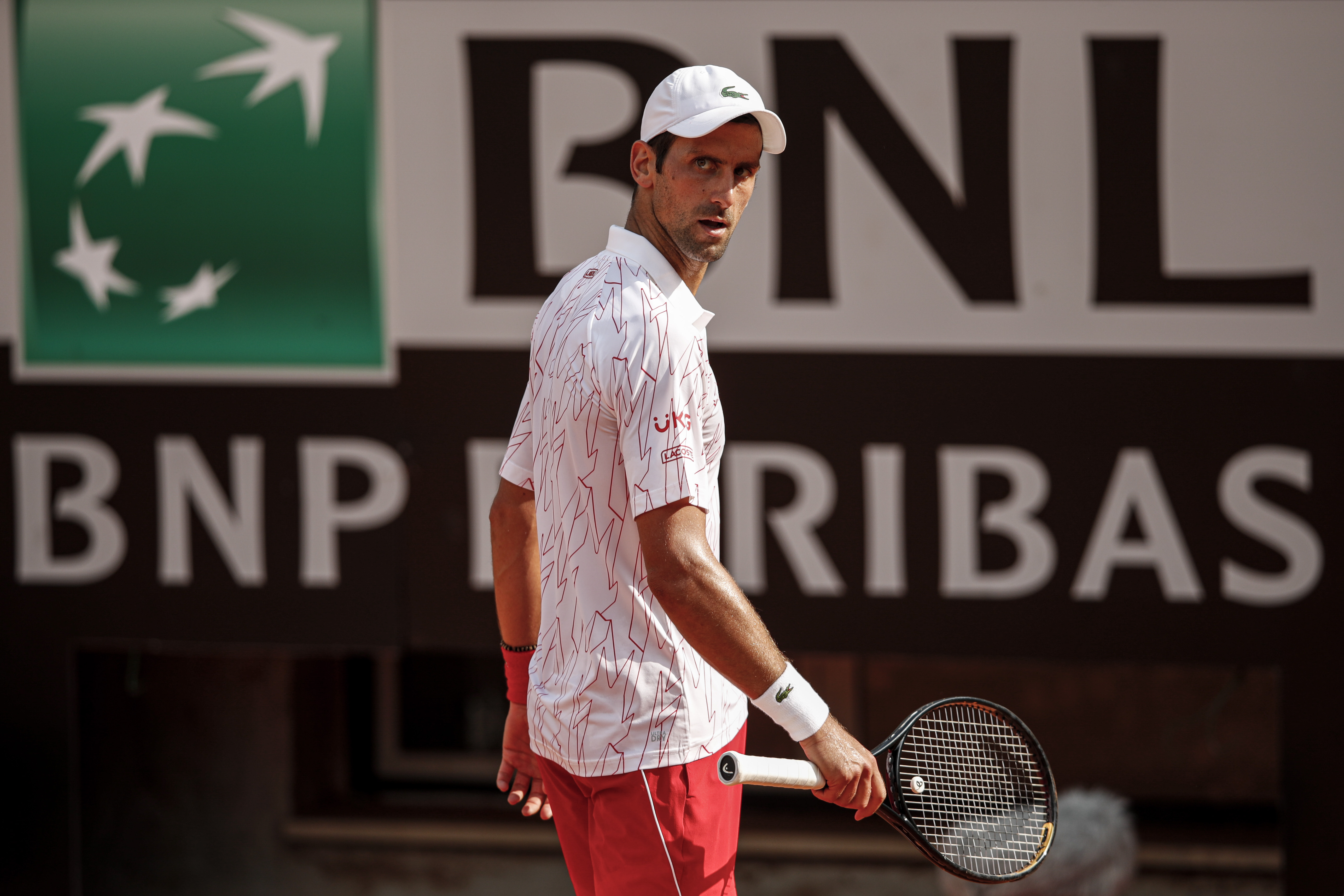 epa08680985 Novak Djokovic of Serbia reacts during his men's singles quarter-finals round match against Dominik Koepfer of Geermany at the Italian Open tennis tournament in Rome, Italy, 19 September 2020.  EPA-EFE/Clive Brunskill / POOL