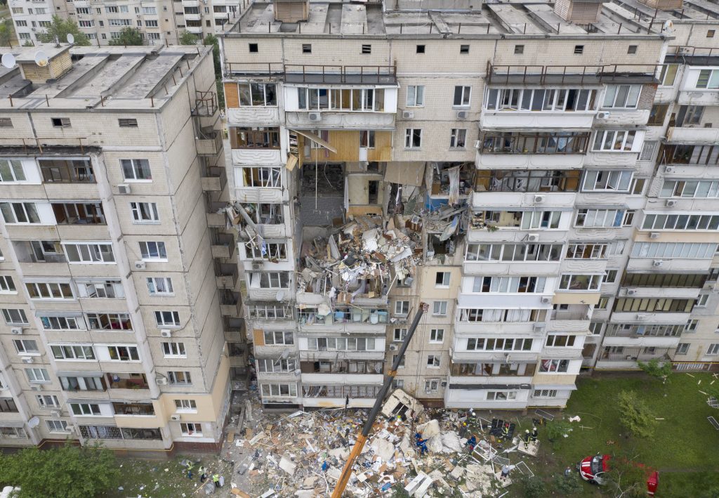 Rescuers work on a site of a deadly gas explosion in a multistory apartment building in Kyiv, Ukraine, Sunday, June 21, 2020. A powerful gas explosion killed at least two people with more unaccounted for, police said. (AP Photo/Efrem Lukatsky)