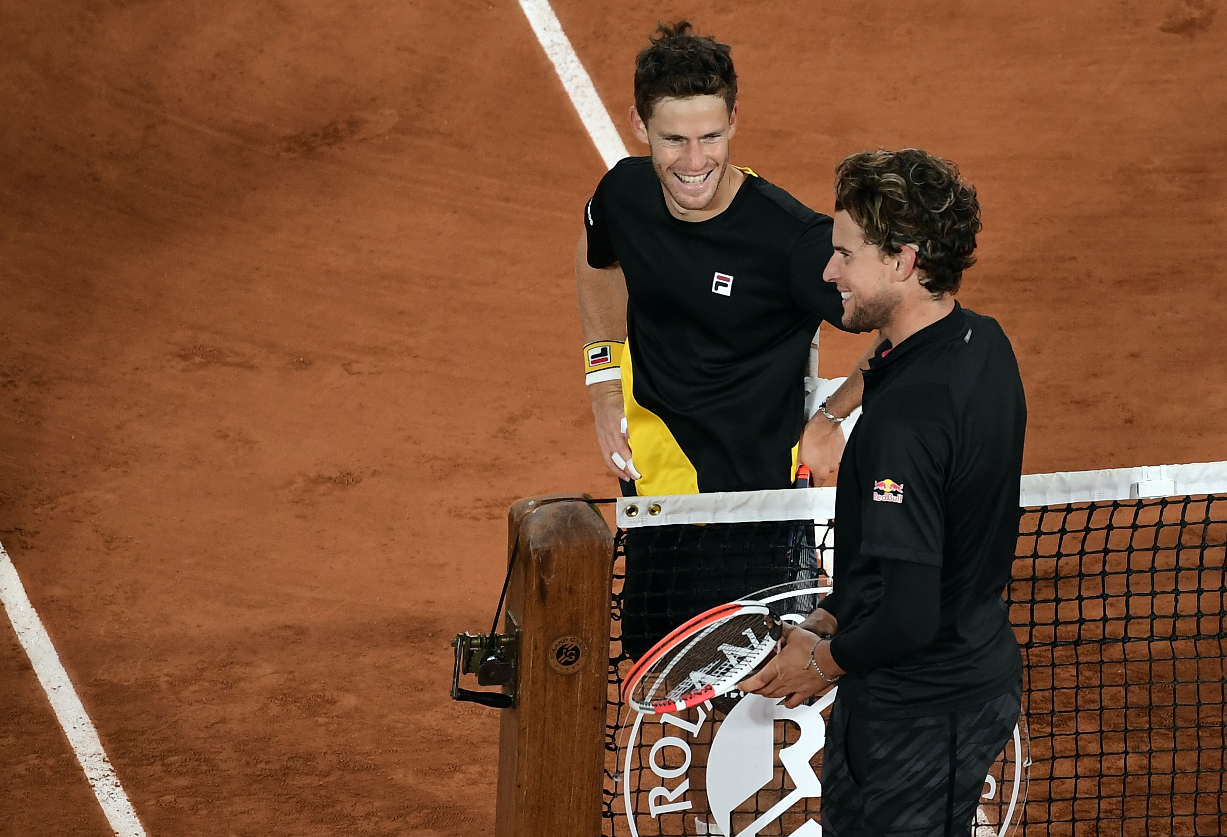 epa08725082 Diego Schwartzman of Argentina (L) reacts with Dominic Thiem of Austria after winning their men?s quarter final match during the French Open tennis tournament at Roland ?Garros in Paris, France, 06 October 2020.  EPA-EFE/JULIEN DE ROSA