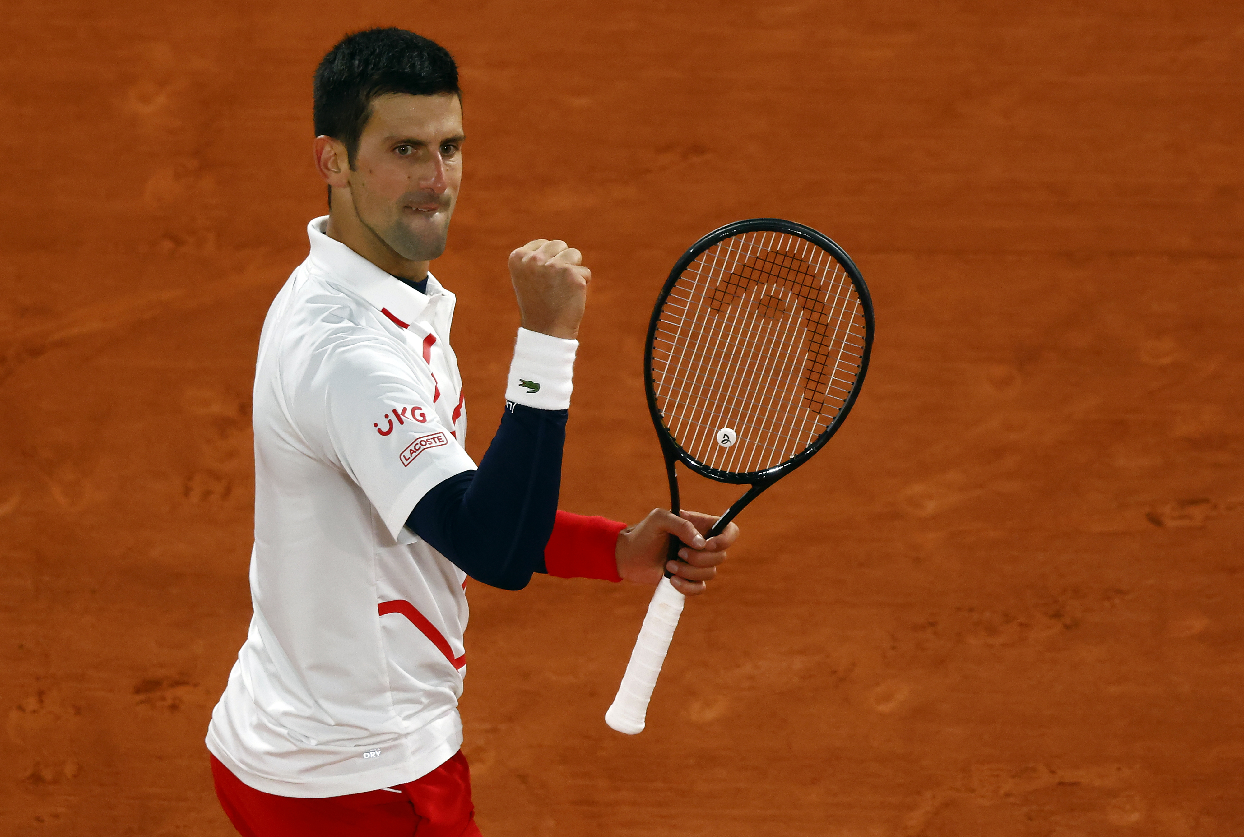 epa08727668 Novak Djokovic of Serbia reacts as he plays Pablo Carreno Busta of Spain during their men?s quarter final match during the French Open tennis tournament at Roland ?Garros in Paris, France, 07 October 2020.  EPA-EFE/IAN LANGSDON