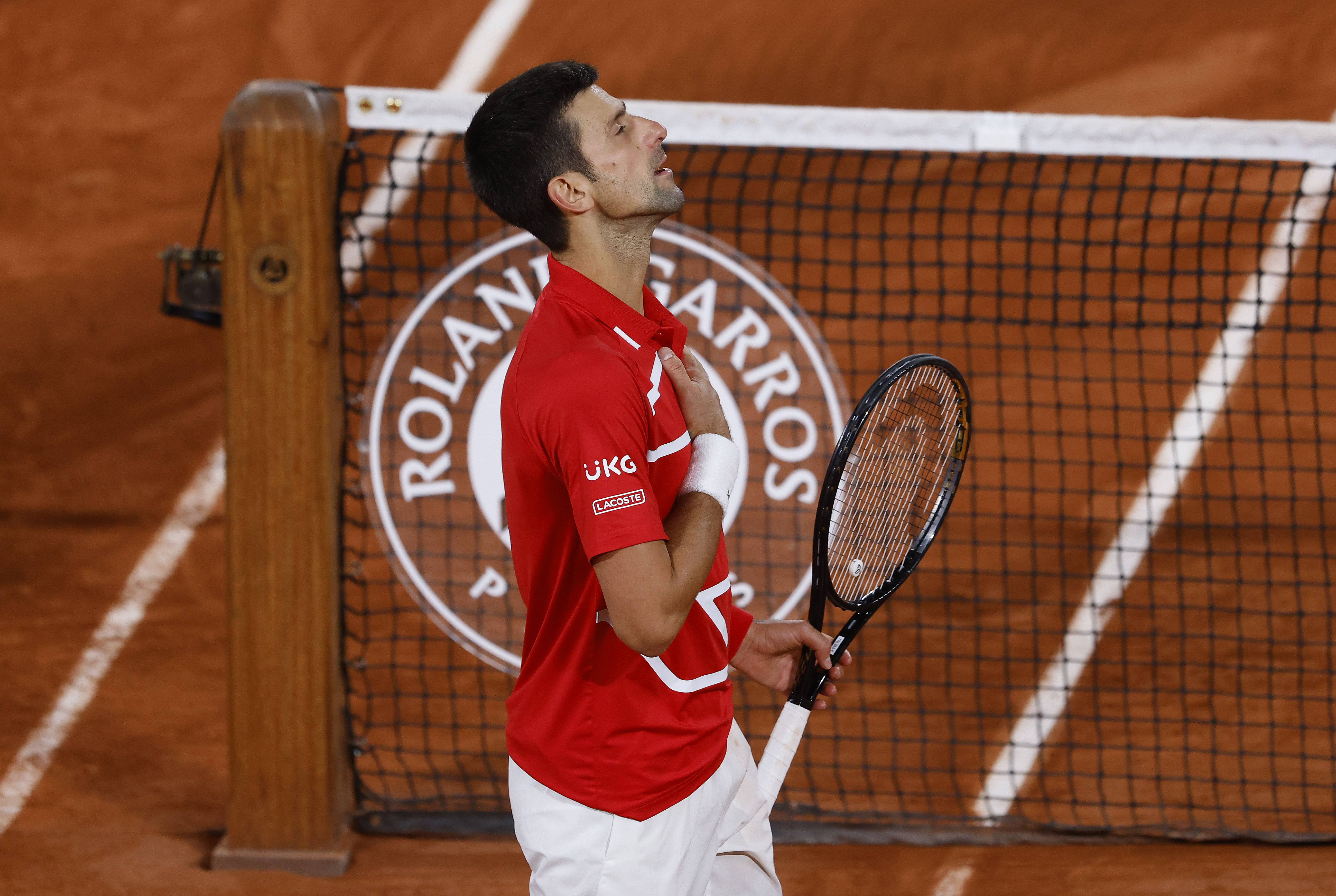 epa08733037 Novak Djokovic of Serbia reacts after winning against Stefanos Tsitsipas of Greece in their men?s semi final match during the French Open tennis tournament at Roland ?Garros in Paris, France, 09 October 2020.  EPA-EFE/YOAN VALAT