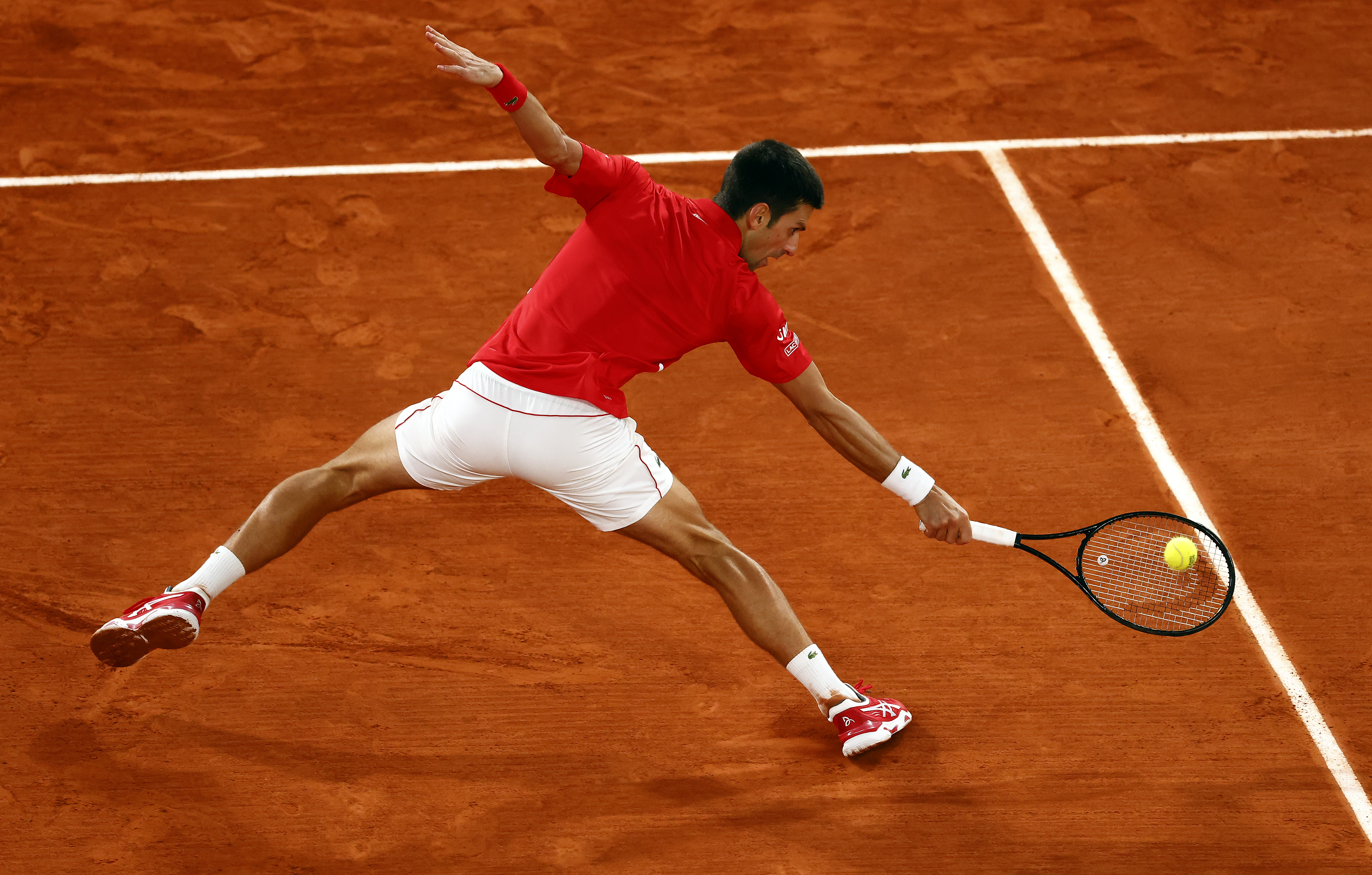 epa08735969 Novak Djokovic of Serbia in action against Rafael Nadal of Spain during their men?s final match during the French Open tennis tournament at Roland ?Garros in Paris, France, 11 October 2020.  EPA-EFE/IAN LANGSDON