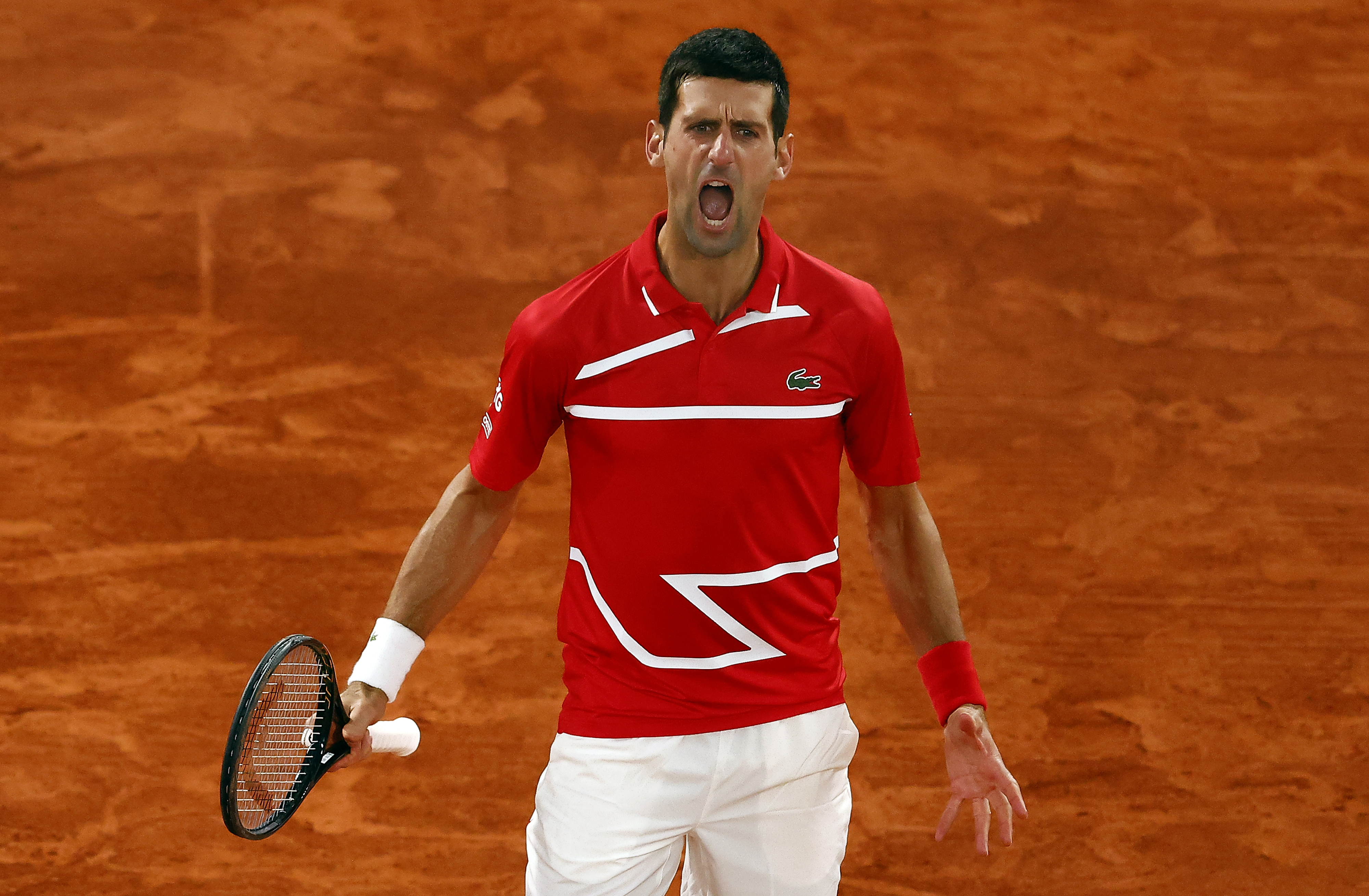 epa08735963 Novak Djokovic of Serbia reacts as he plays Rafael Nadal of Spain during their men?s final match during the French Open tennis tournament at Roland ?Garros in Paris, France, 11 October 2020.  EPA-EFE/IAN LANGSDON