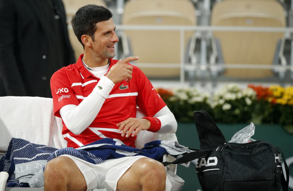 epa08735542 Novak Djokovic of Serbia reacts during a break as he plays Rafael Nadal of Spain during their men?s final match during the French Open tennis tournament at Roland ?Garros in Paris, France, 11 October 2020.  EPA-EFE/YOAN VALAT