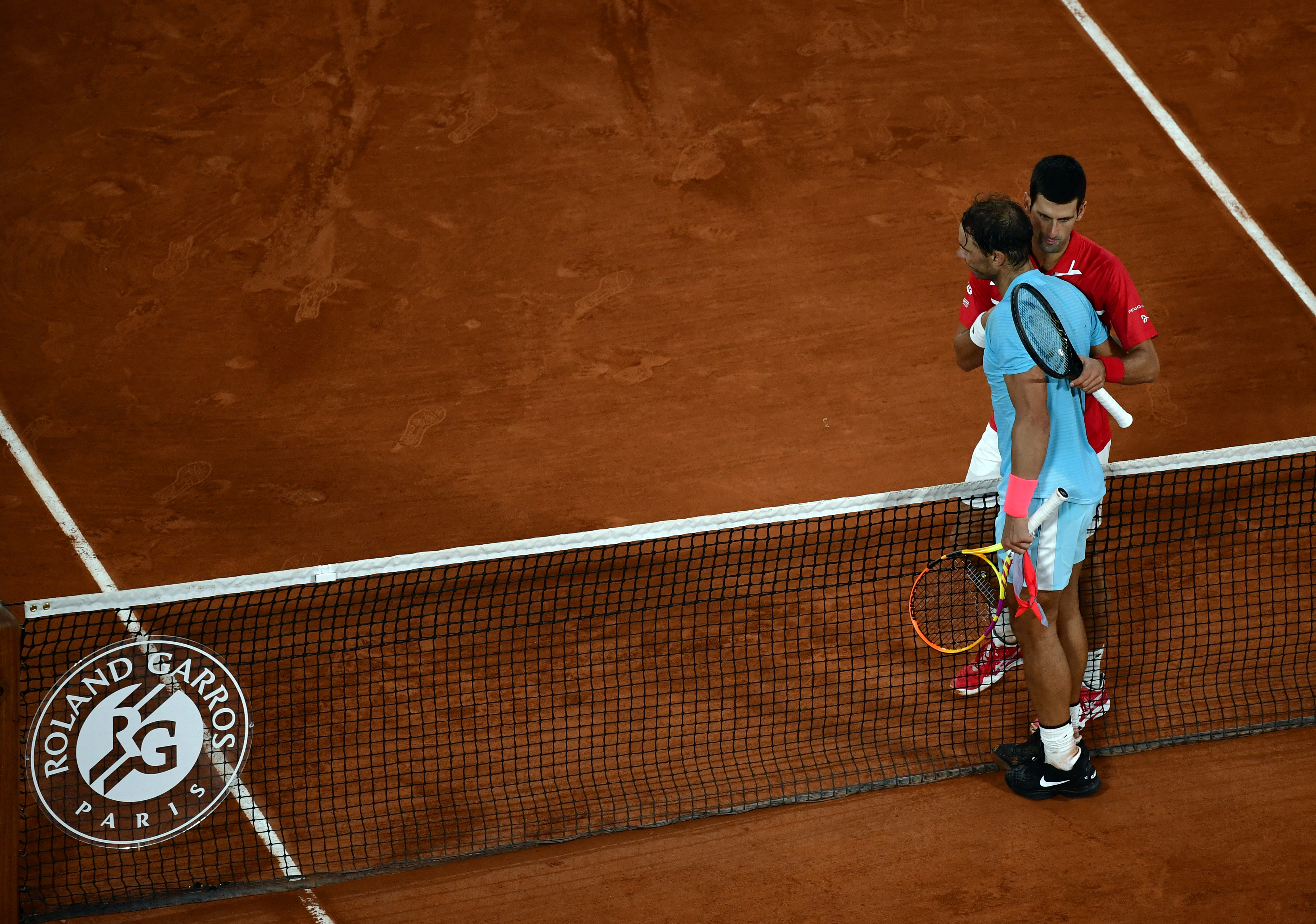epa08736025 Rafael Nadal of Spain (L) reacts with Novak Djokovic of Serbia after winning their men?s final match during the French Open tennis tournament at Roland ?Garros in Paris, France, 11 October 2020.  EPA-EFE/JULIEN DE ROSA