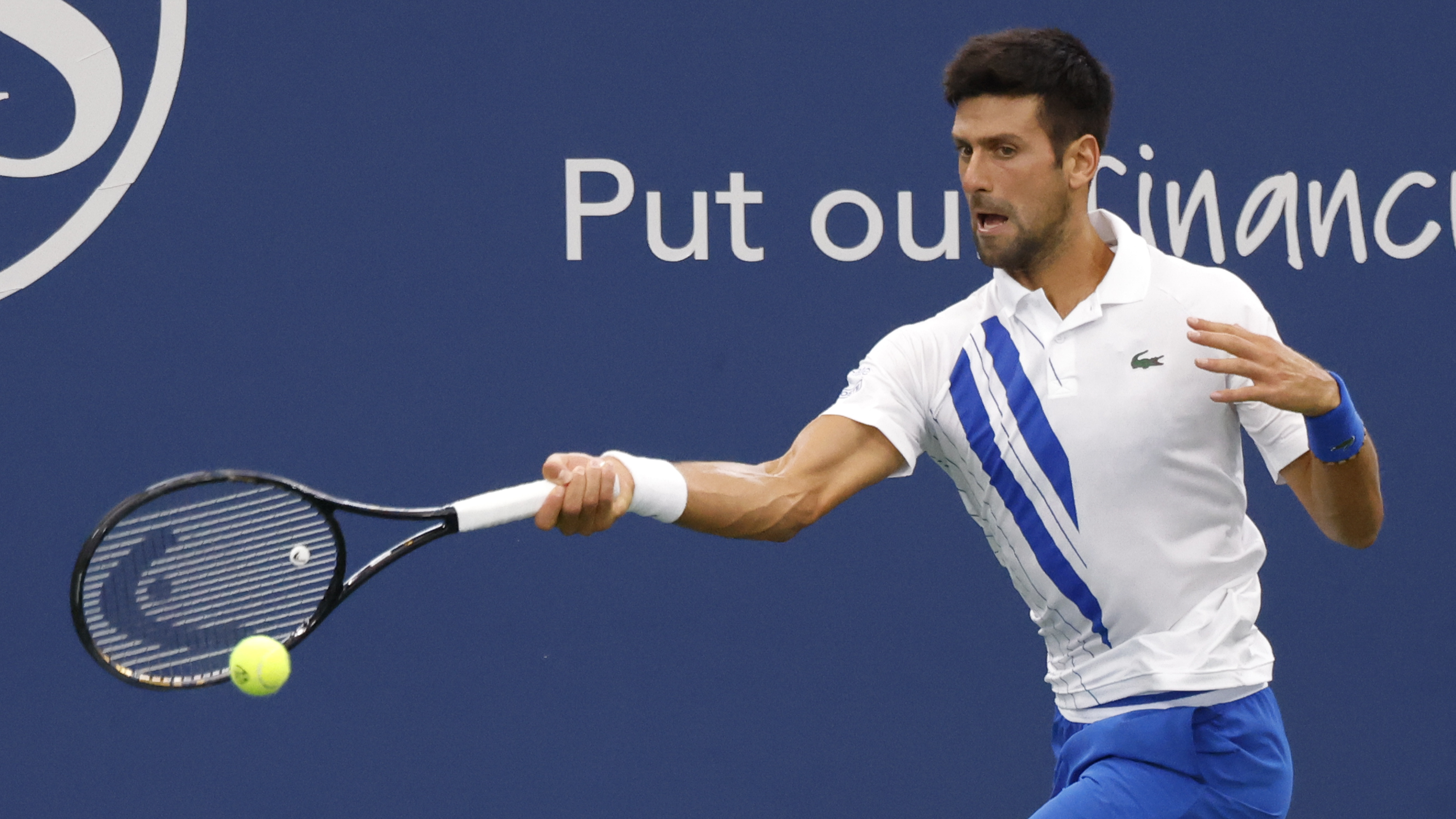 epa08634349 Novak Djokovic of Serbia in action against Milos Raonic of Canada during their Finals match at the Western and Southern Open at the USTA National Tennis Center in Flushing Meadows, New York, USA, 29 August 2020.  EPA-EFE/JASON SZENES