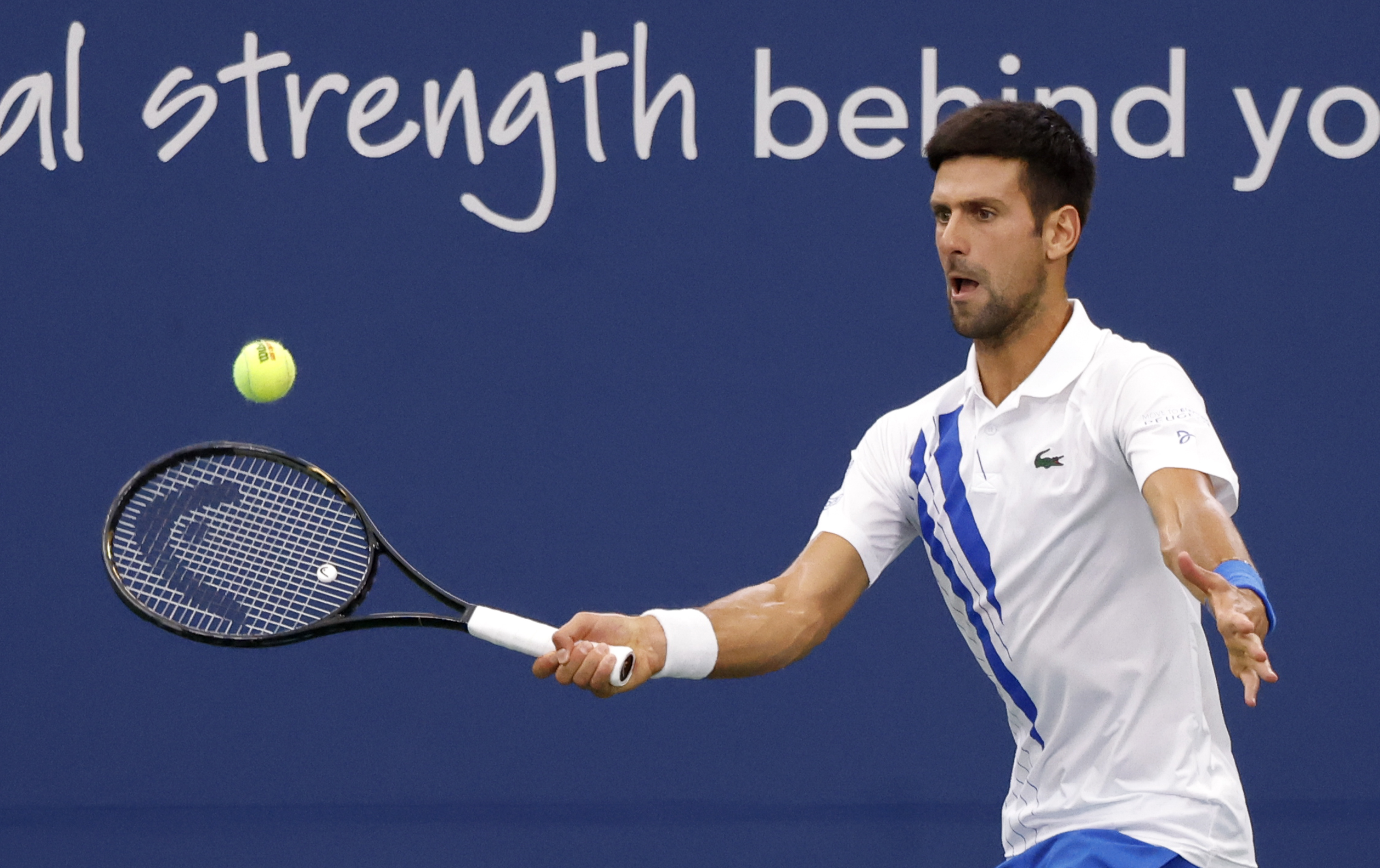 epa08634350 Novak Djokovic of Serbia in action against Milos Raonic of Canada during their Finals match at the Western and Southern Open at the USTA National Tennis Center in Flushing Meadows, New York, USA, 29 August 2020.  EPA-EFE/JASON SZENES