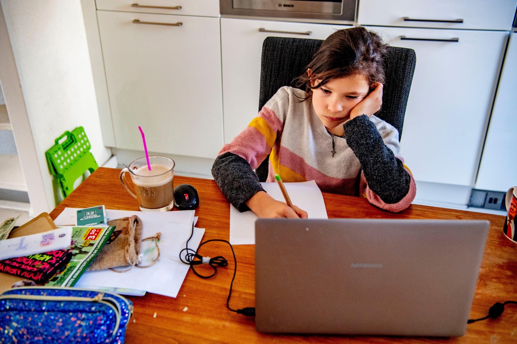 A 9 year old girl writes down her online notes while she is at home under the supervision of her primary school teacher.The Dutch government ordered all schools to be closed until further notice in attempt to control the spread of the COVID-19 Coronavirus