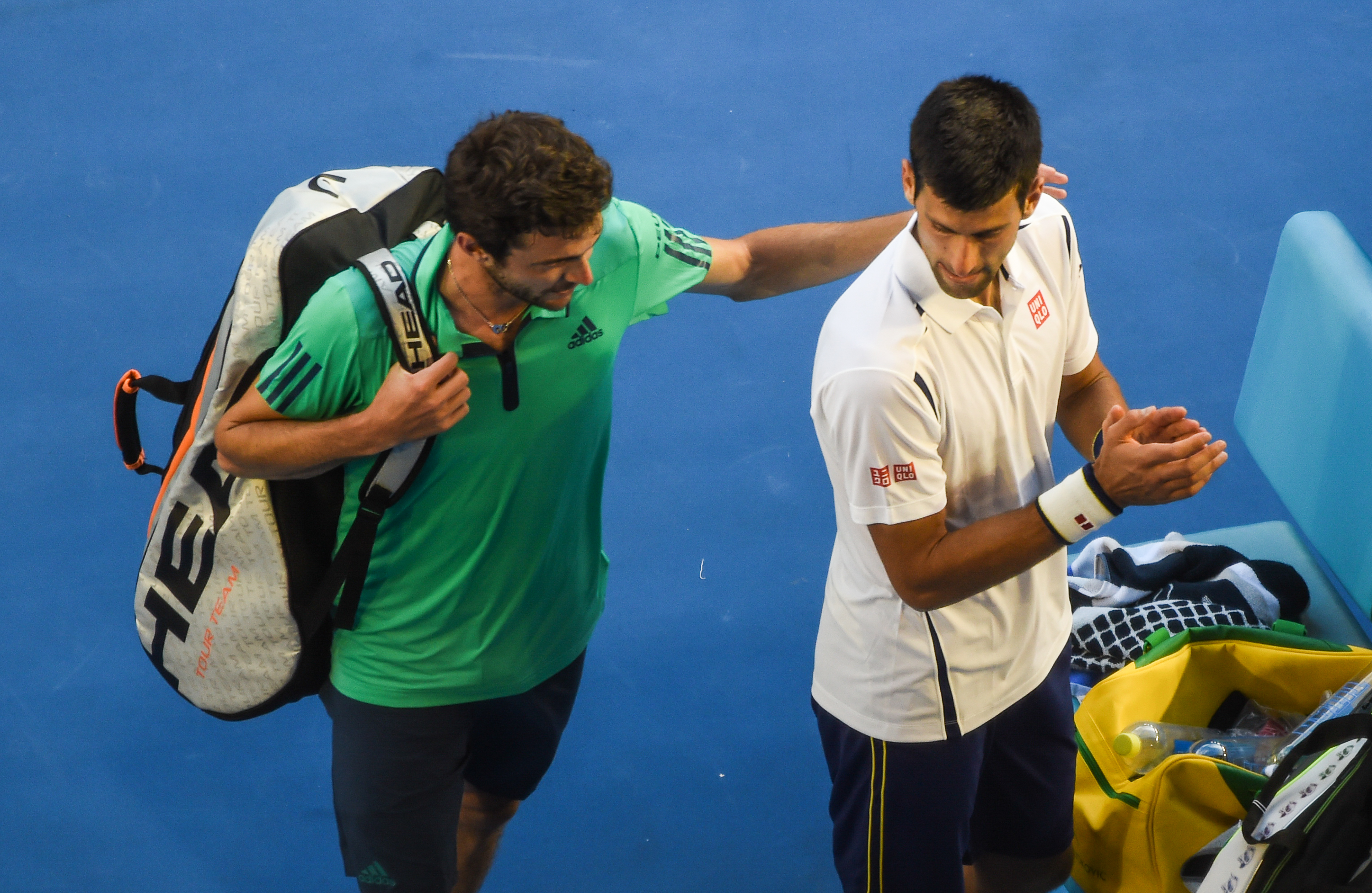 epa05122185 Novak Djokovic (R) of Serbia reacts after defeating Gilles Simon of France in their fourth round match on day seven of the Australian Open tennis tournament in Melbourne, Australia, 24 January 2016  EPA/FILIP SINGER