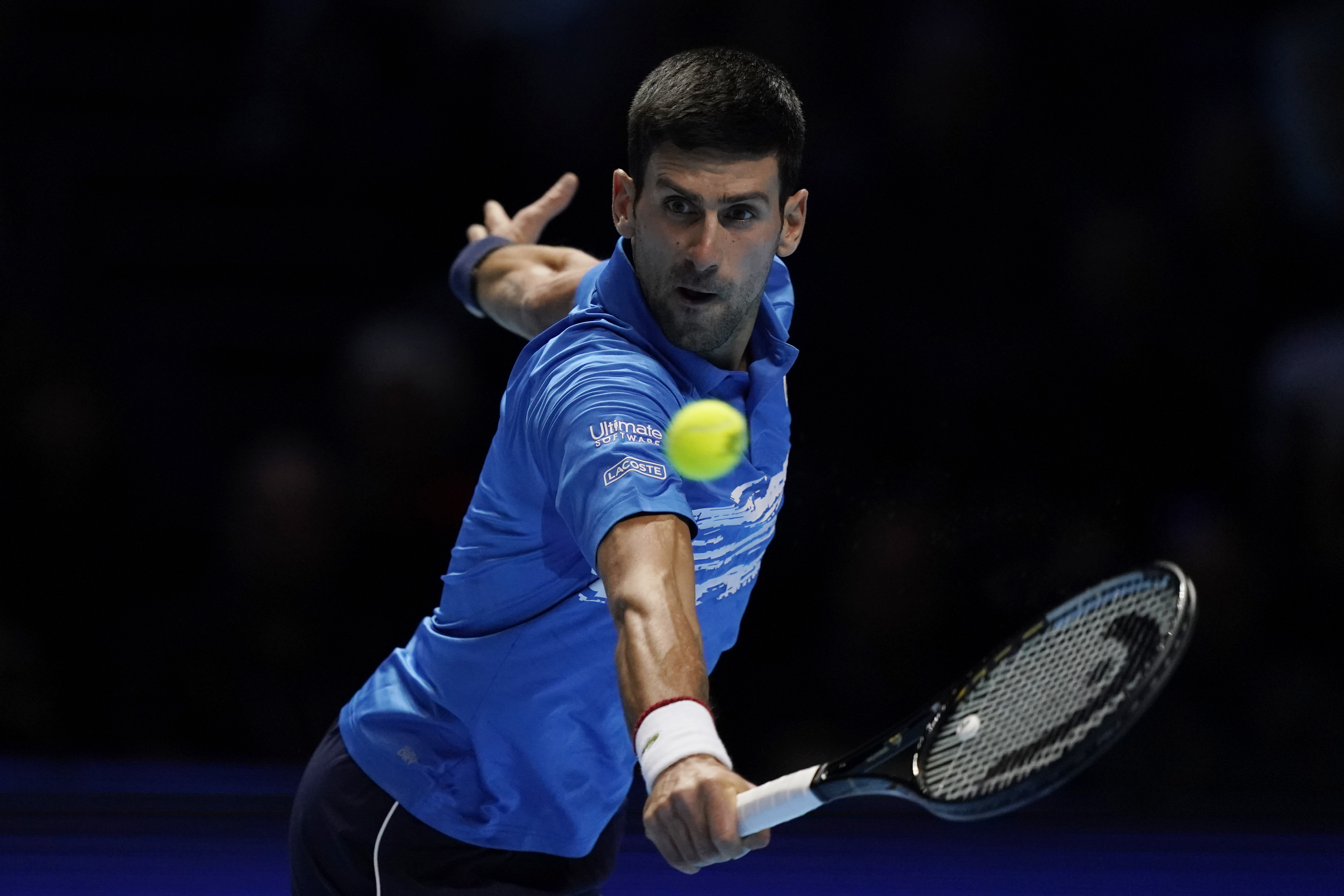 epa07996945 Novak Djokovic of Serbia returns to Roger Federer of Switzerland during his round robin match against at the ATP World Tour Finals tennis tournament in London, Britain, 14 November 2019.  EPA-EFE/WILL OLIVER