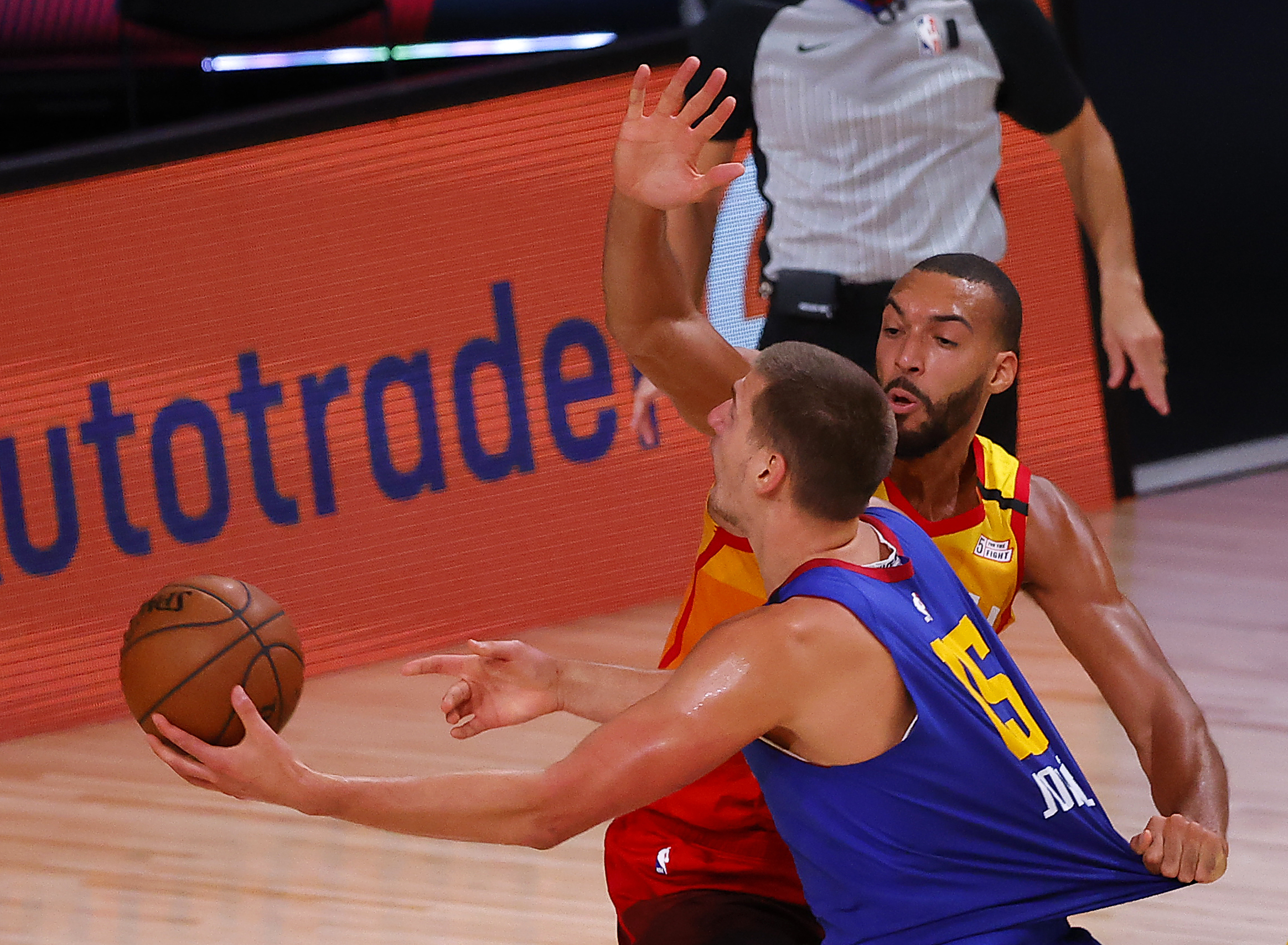 Denver Nuggets' Nikola Jokic (15) handles the ball as Utah Jazz's Rudy Gobert defends during the third quarter of an NBA basketball game Saturday, Aug. 8, 2020, in Lake Buena Vista, Fla. (Kevin C. Cox/Pool Photo via AP)
