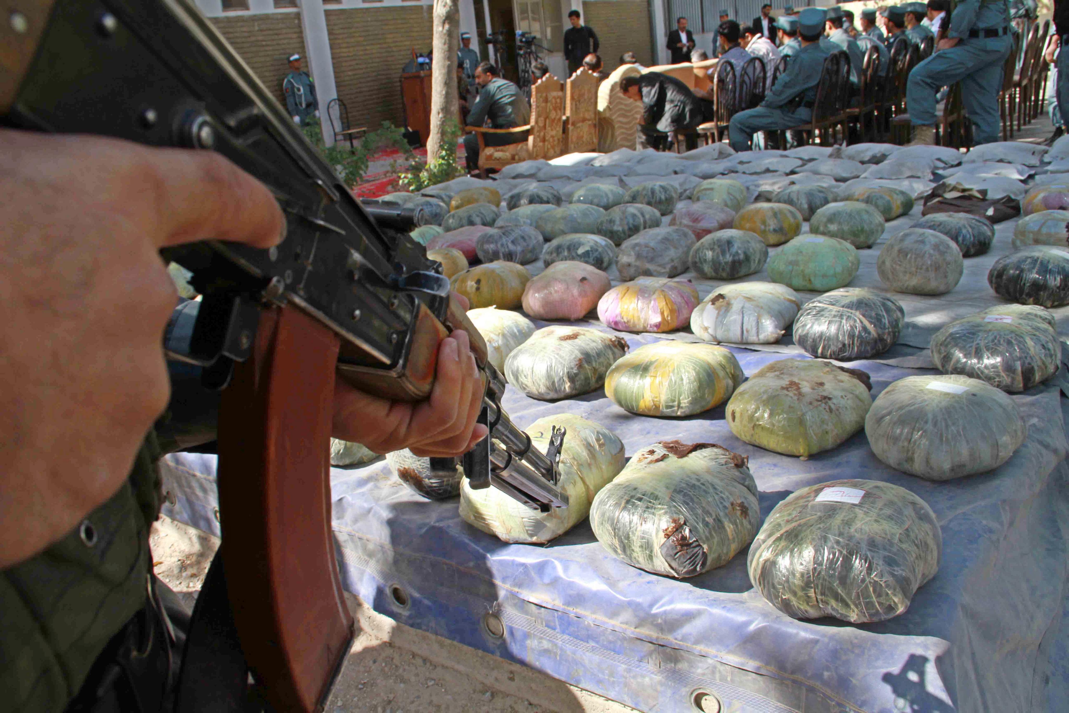 Afghan Officials Inspect raw heroin