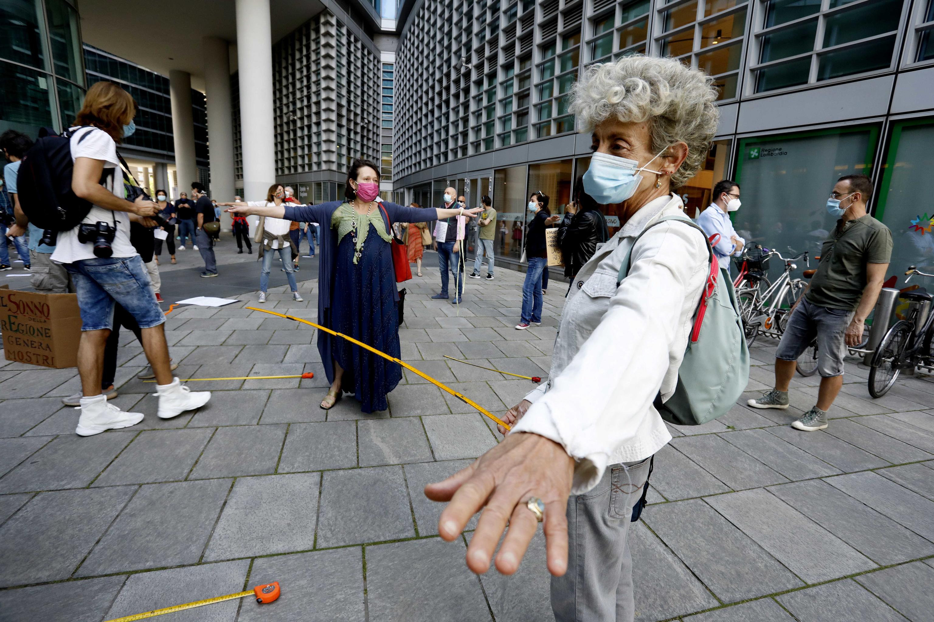 epa08452545 People gather for a flash mob in Piazza Citta di Lombardia to protest against the leadership of the Lombardy Region for the management of the coronavirus health emergency in Milan, Italy, 29 May 2020.  EPA-EFE/Mourad Balti Touati