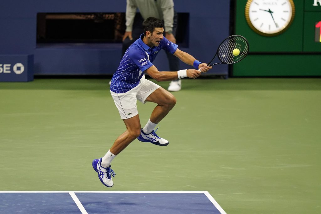 Novak Djokovic, of Serbia, returns to Damir Dzumhur, of Bosnia and Herzegovina, during the first round of the US Open tennis championships, Monday, Aug. 31, 2020, in New York. (AP Photo/Frank Franklin II)