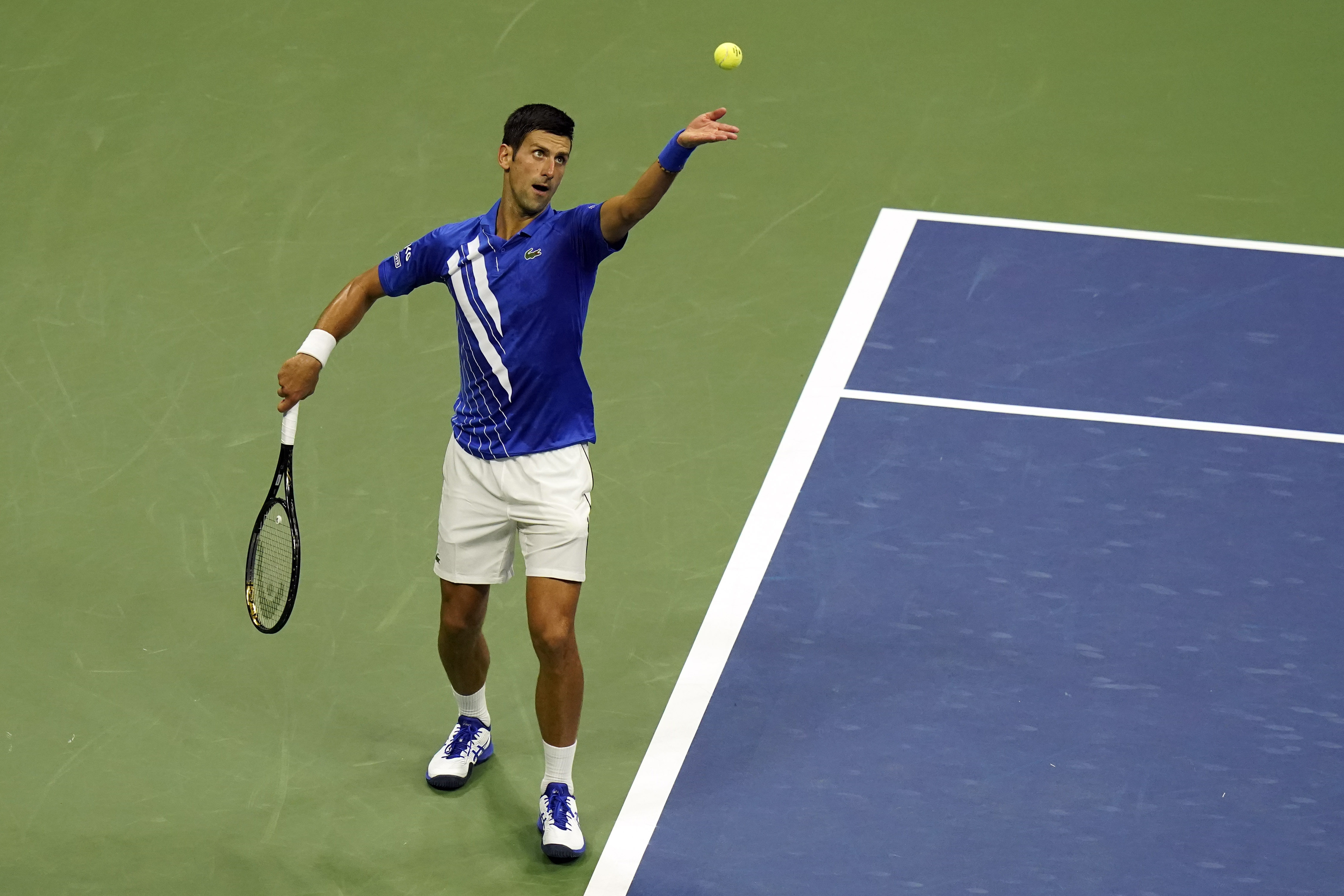 Novak Djokovic, of Serbia, serves to Damir Dzumhur, of Bosnia and Herzegovina, during the first round of the US Open tennis championships, Monday, Aug. 31, 2020, in New York. (AP Photo/Frank Franklin II)