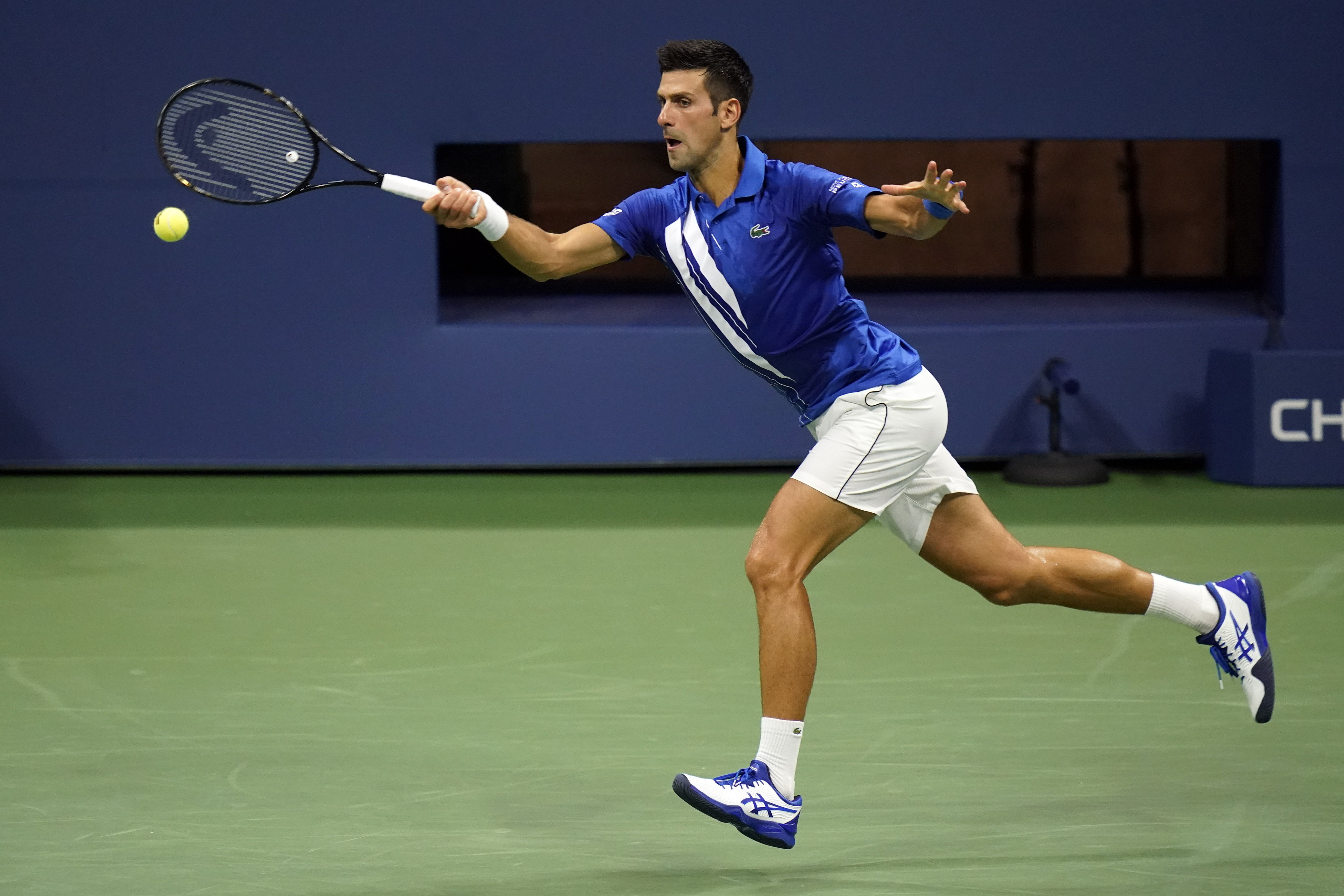 Novak Djokovic, of Serbia, returns to Damir Dzumhur, of Bosnia and Herzegovina, during the first round of the US Open tennis championships, Monday, Aug. 31, 2020, in New York. (AP Photo/Frank Franklin II)