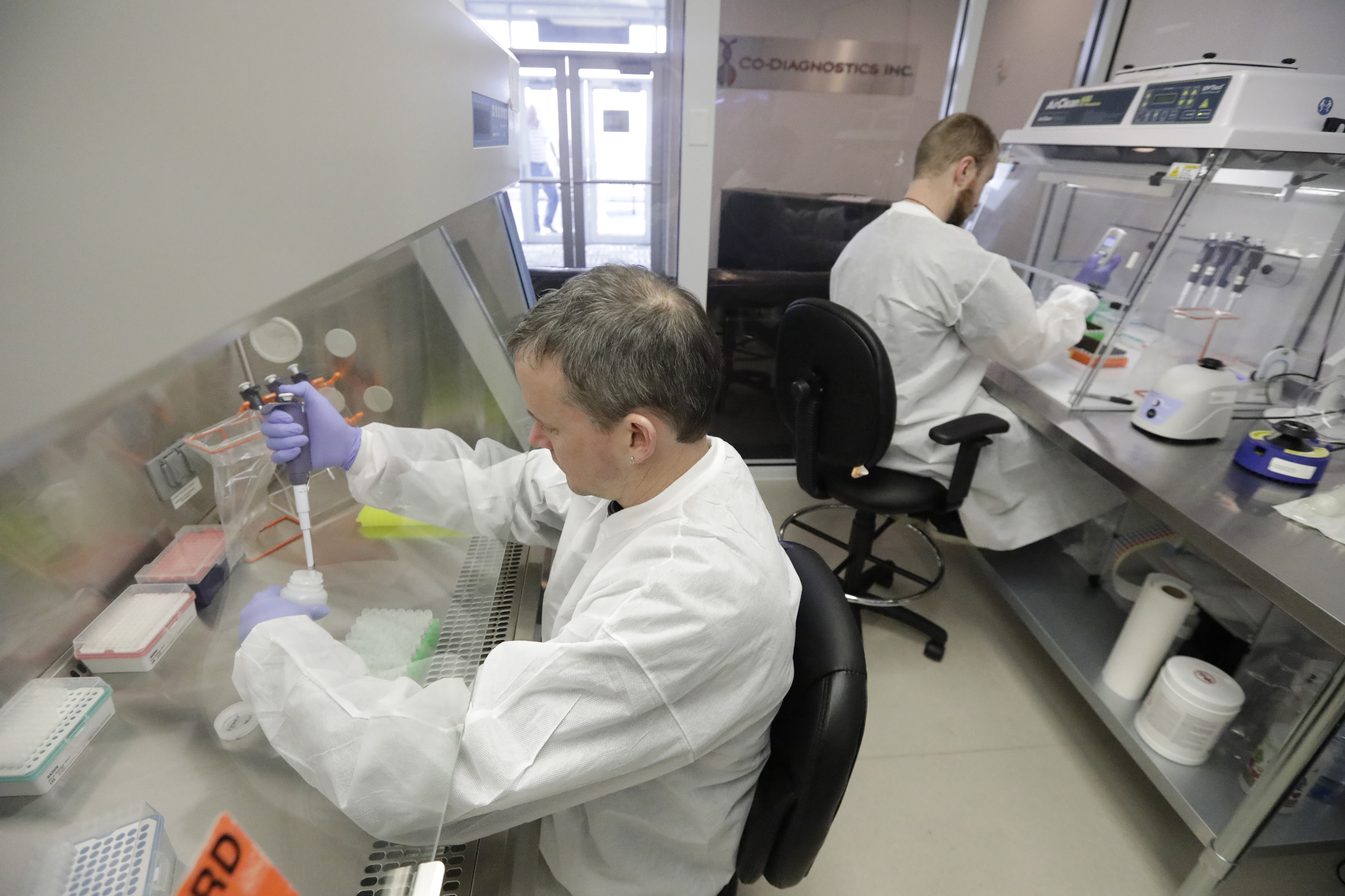 Co-Diagnostics lab technicians manufacture COVID-19 testing kits Friday, March 27, 2020, in Salt Lake City. The company says it has the capacity to produce 50,000 test kits daily from its Salt Lake City facility. (AP Photo/Rick Bowmer)