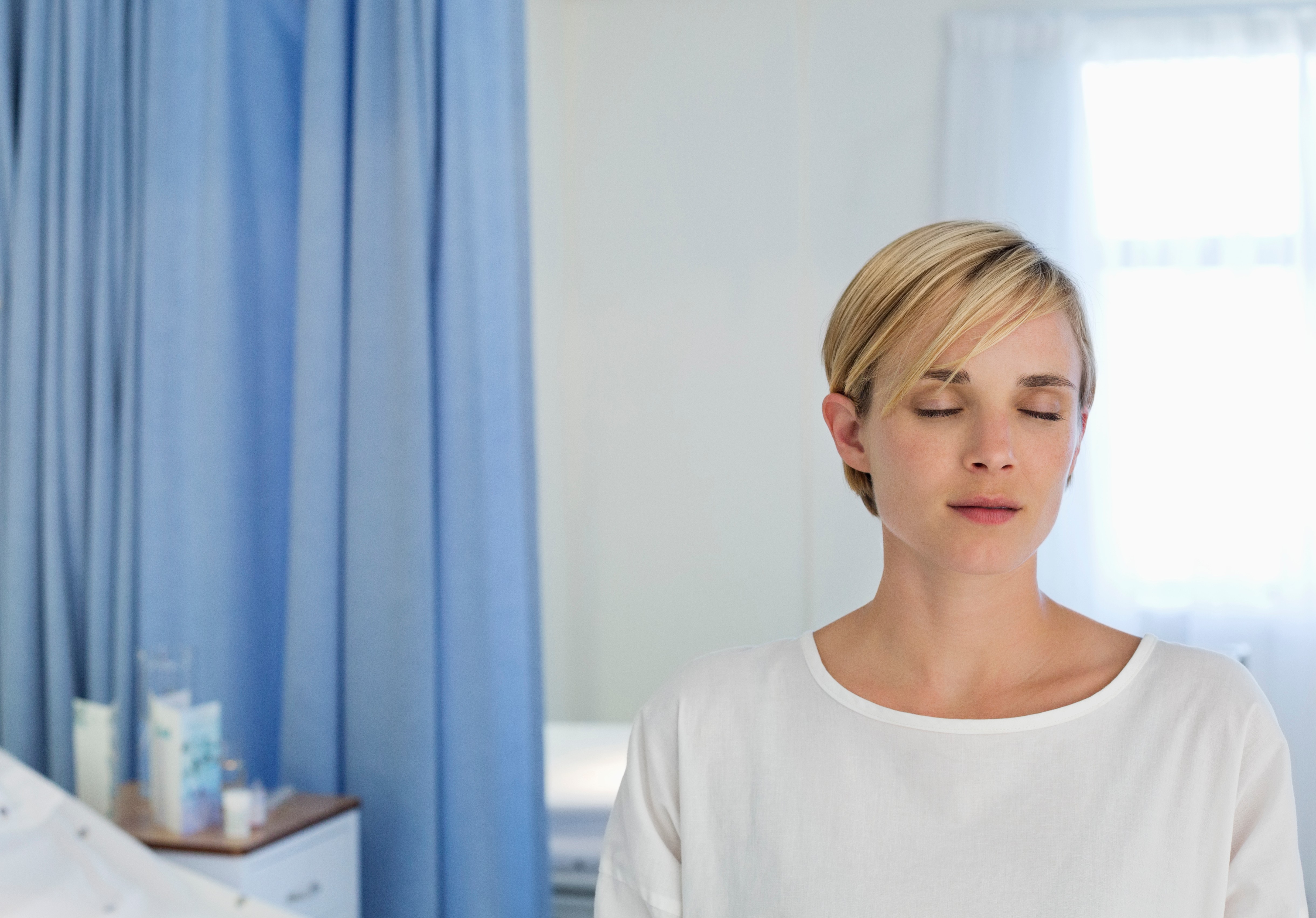 Patient sitting on bed in hospital room
