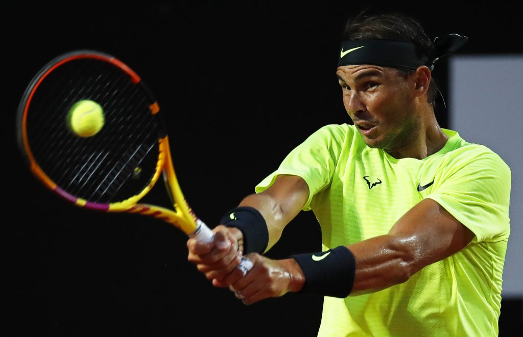 epa08679280 Rafael Nadal of Spain in action against Dusan Lajovic of Serbia during their men's singles third round match at the Italian Open tennis tournament in Rome, Italy, 18 September 2020.  EPA-EFE/Clive Brunskill / POOL