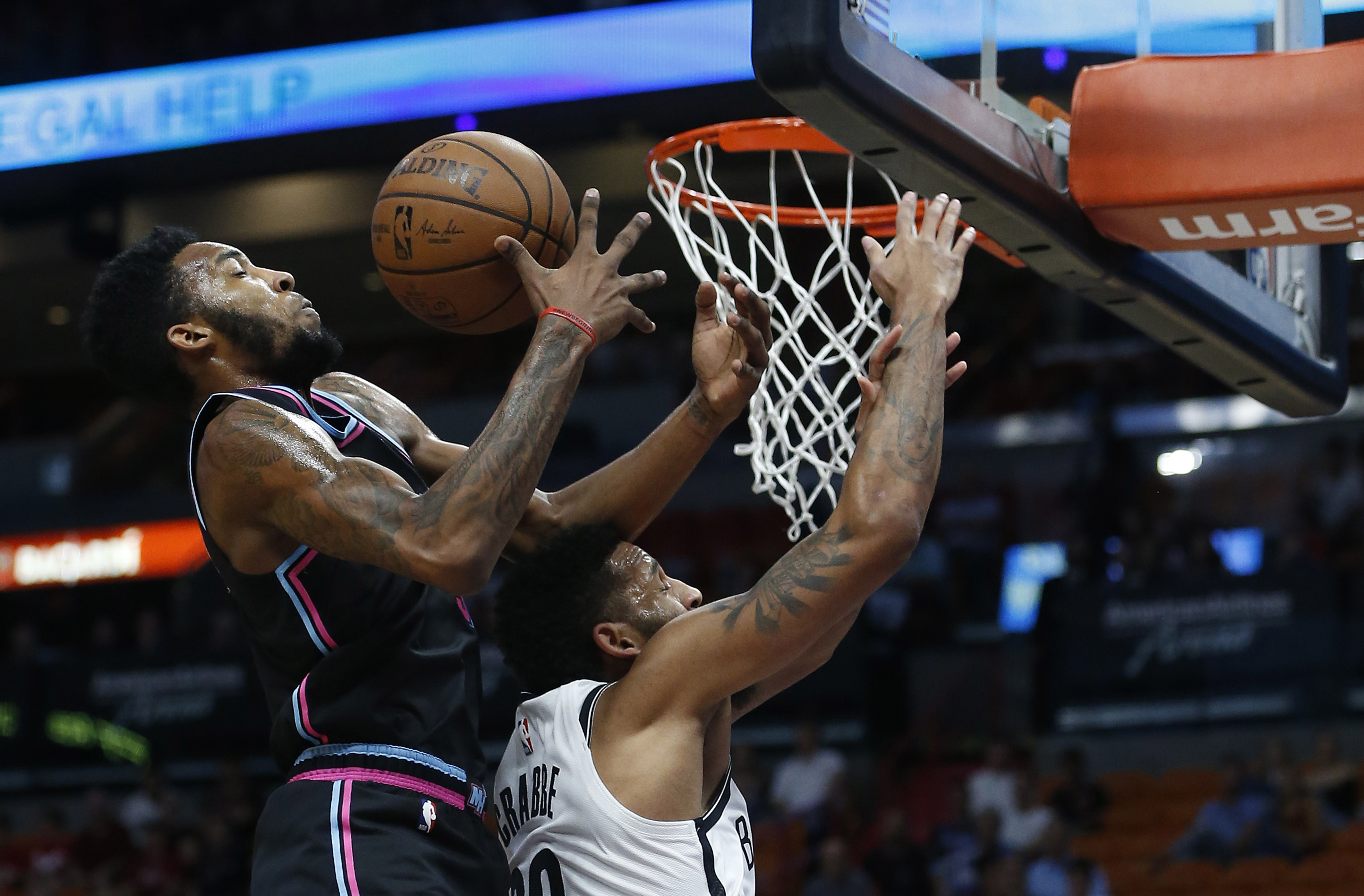 epa07180539 Brooklyn Nets forward Allen Crabbe (R) sand Miami Heat guard Derrick Jones Jr. (L) fight for a rebound during their game at the American Airlines Arena in Miami, Florida, USA, 20 November 2018.  EPA-EFE/RHONA WISE  SHUTTERSTOCK OUT