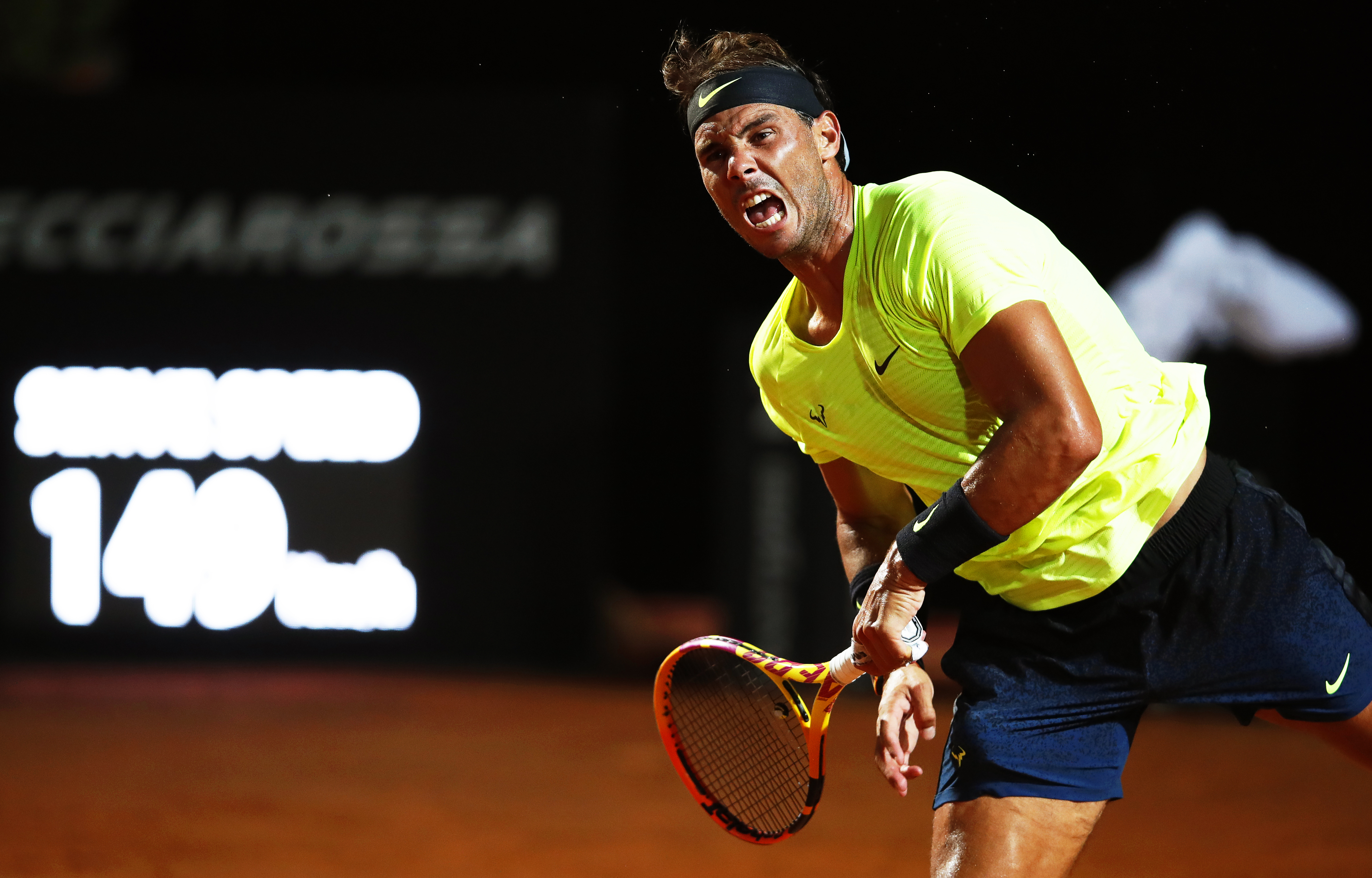 epa08679309 Rafael Nadal of Spain in action against Dusan Lajovic of Serbia during their men's singles third round match at the Italian Open tennis tournament in Rome, Italy, 18 September 2020.  EPA-EFE/Clive Brunskill / POOL