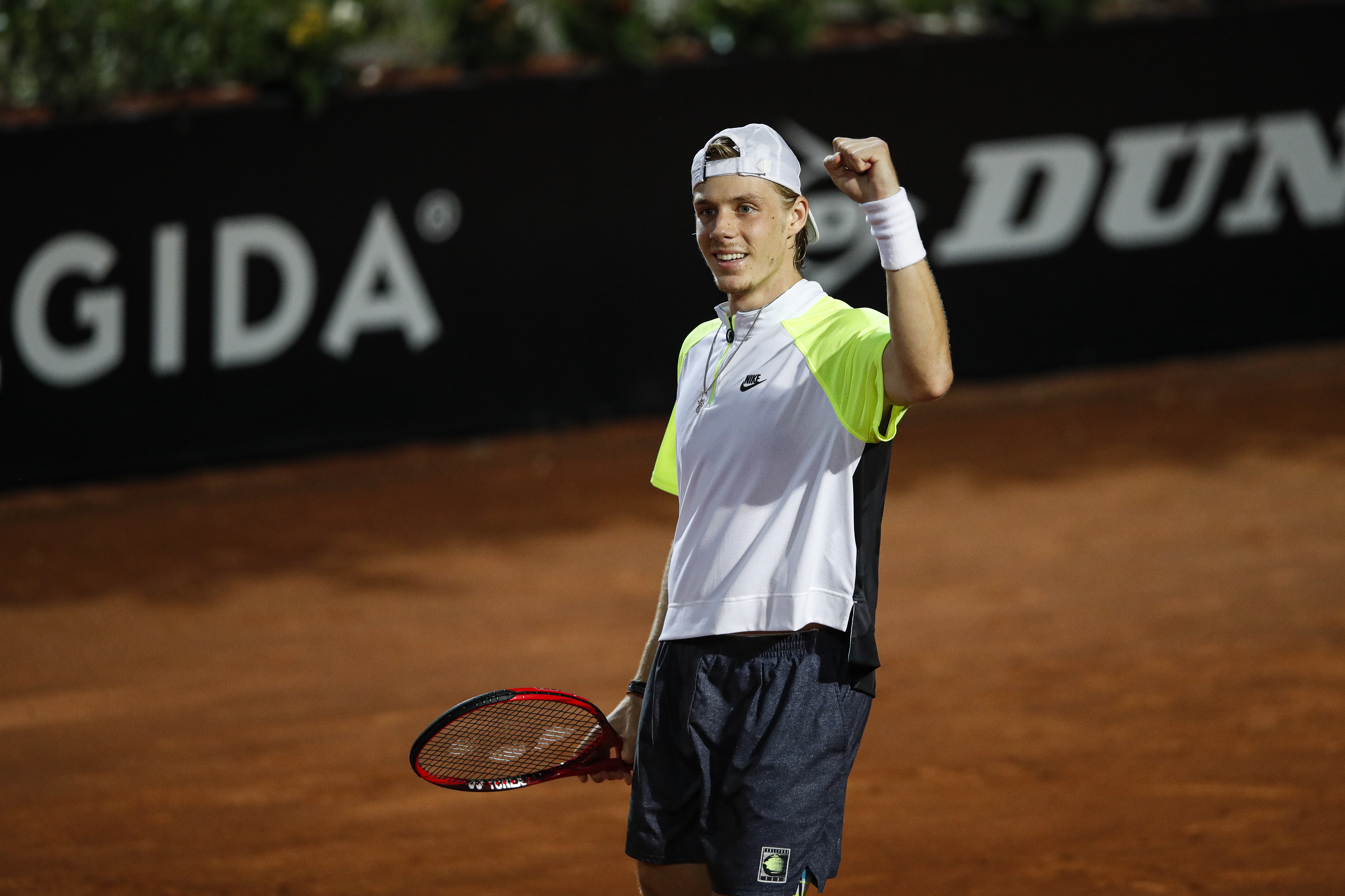 epa08682447 Denis Shapovalov of Canada celebrates after winning his men's singles quarter-finals round match against Grigor Dimitrov of Bulgaria at the Italian Open tennis tournament in Rome, Italy, 19 September 2020.  EPA-EFE/Clive Brunskill / POOL