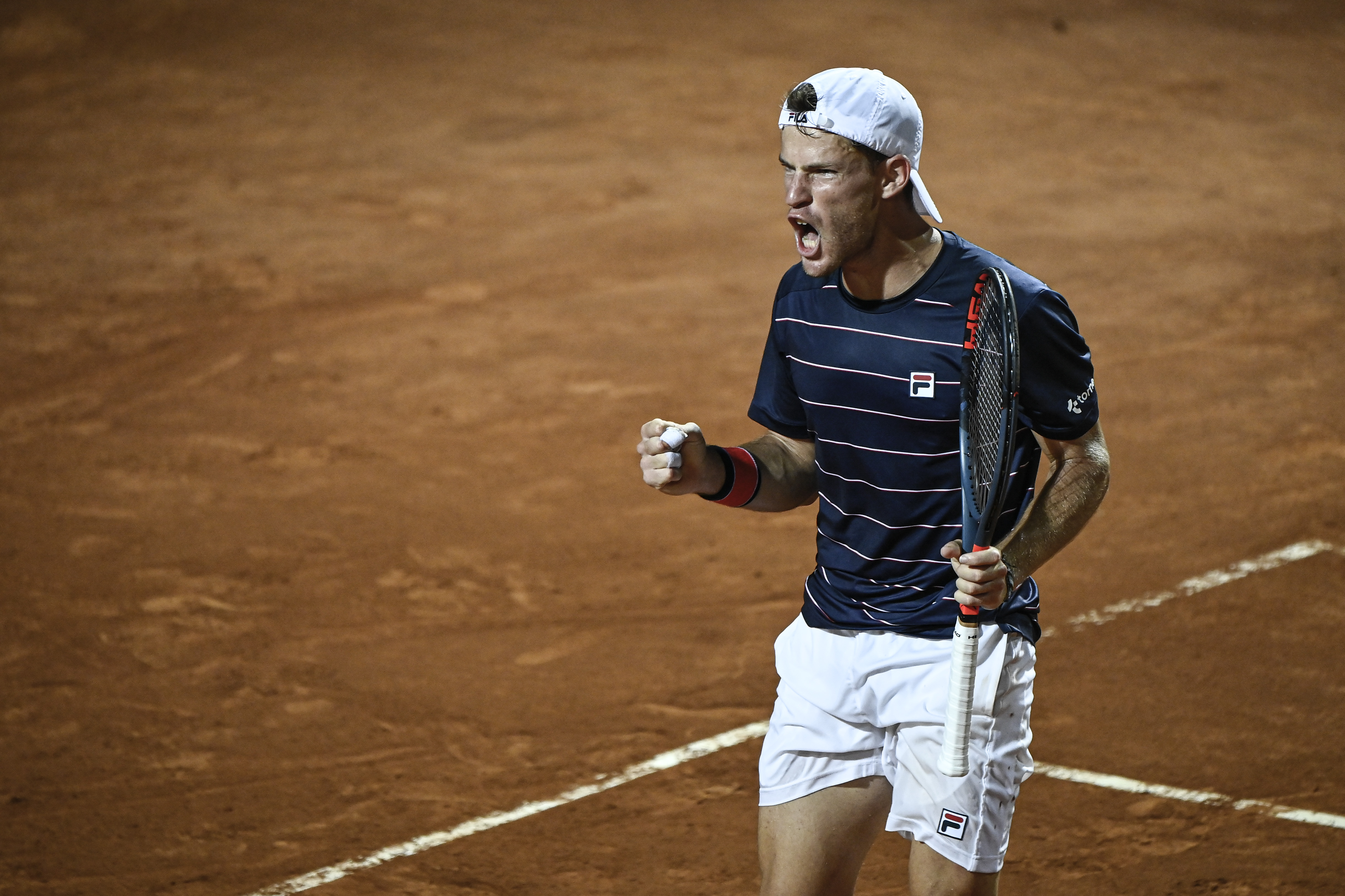 epa08682793 Diego Schwartzman of Argentina celebrates after winning his men's singles quarter-finals round match against Rafael Nadal of Spain at the Italian Open tennis tournament in Rome, Italy, 19 September 2020.  EPA-EFE/Riccardo Antimiani / POOL