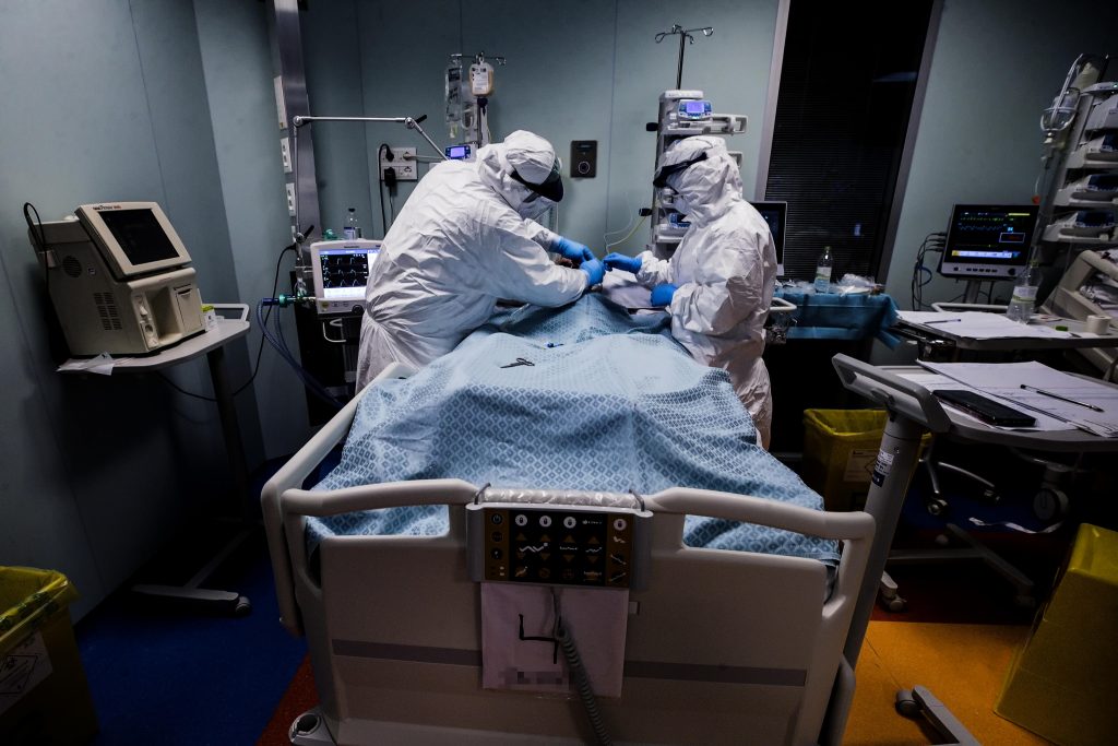 epa08377437 Doctors and nurses wearing protective equipment attend to a patient in the COVID-3 level intensive care unit, treating COVID-19 patients, at the Casal Palocco hospital near Rome, Italy, 22 April 2020.  EPA-EFE/ANGELO CARCONI