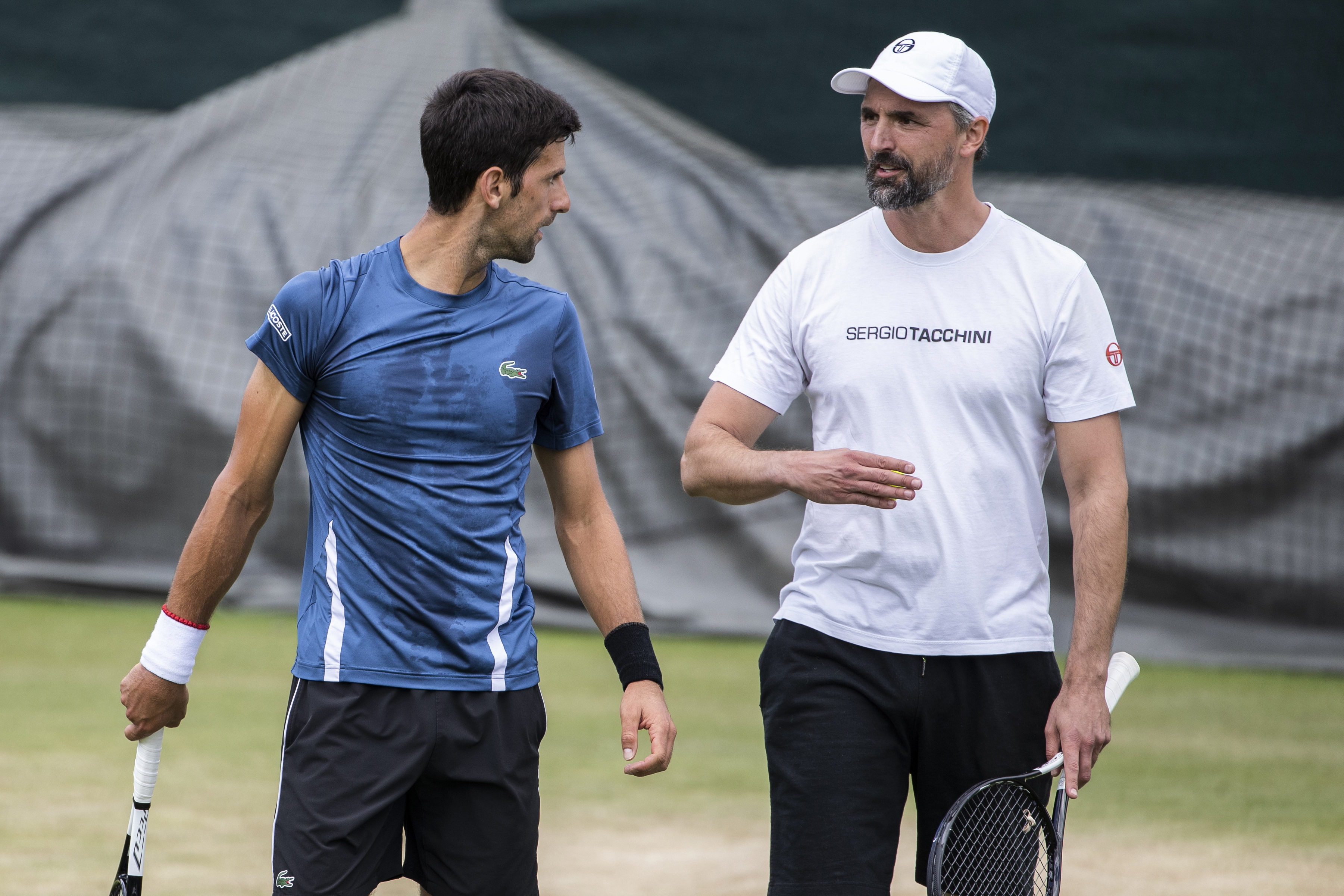 epa07684625 Novak Djokovic of Serbia, left, talks to Goran Ivanisevic during a training session at the All England Lawn Tennis Championships in Wimbledon, London, on Sunday, June 30, 2019.  EPA-EFE/PETER KLAUNZER EDITORIAL USE ONLY; NO SALES, NO ARCHIVES