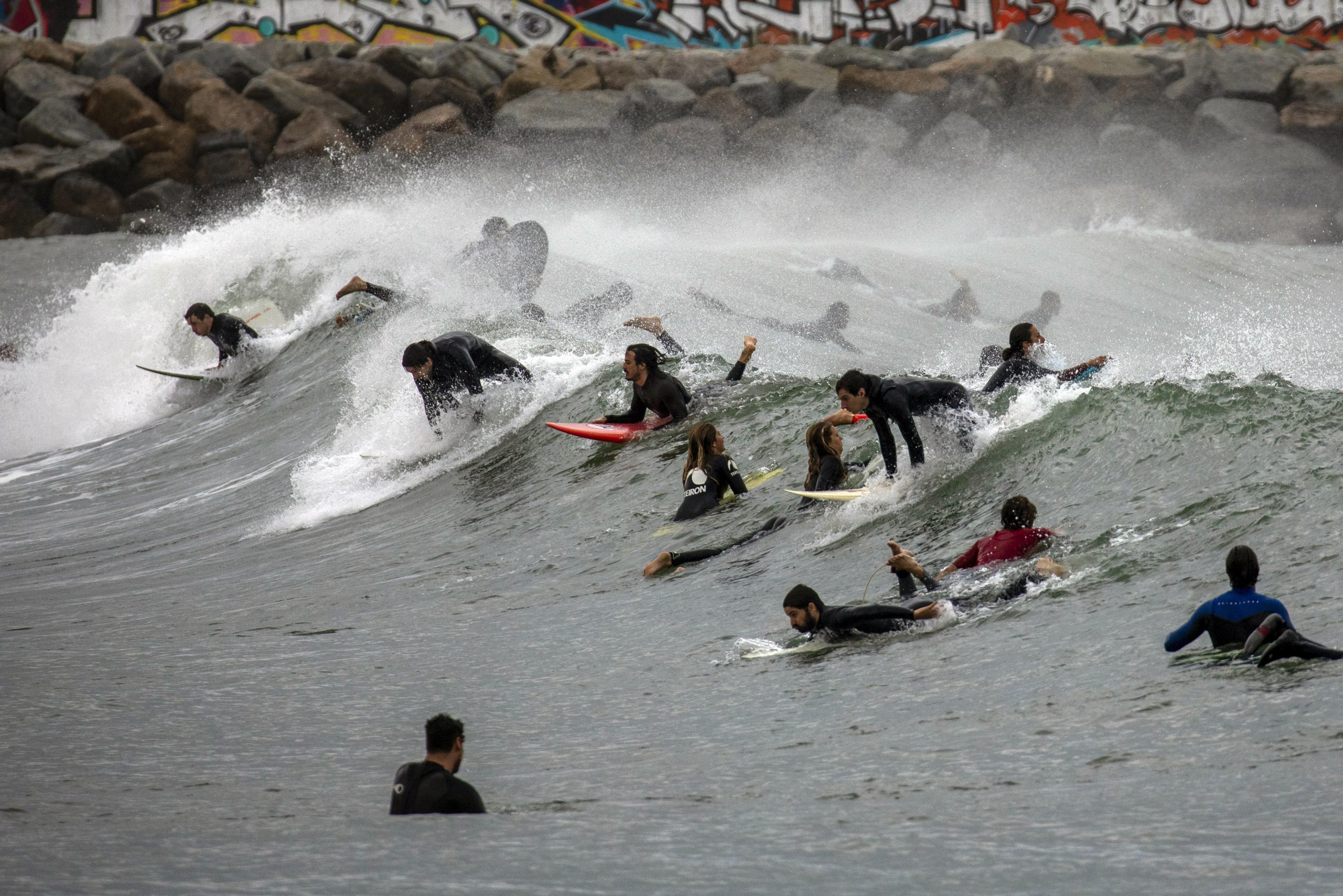 eople surf on a beach reopened for sport activities after the lockdown measures imposed by the government due to coronavirus, in Barcelona, Spain, Saturday, May 9, 2020. (AP Photo/Emilio Morenatti)