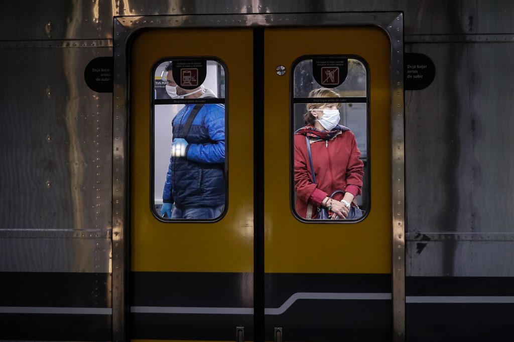 epaselect epa08362764 Two people with masks are seen in a subway car in the city of Buenos Aires, Argentina 14 April 2020, after the government announced the mandatory use of mask from April 15.  EPA-EFE/Juan Ignacio Roncoroni