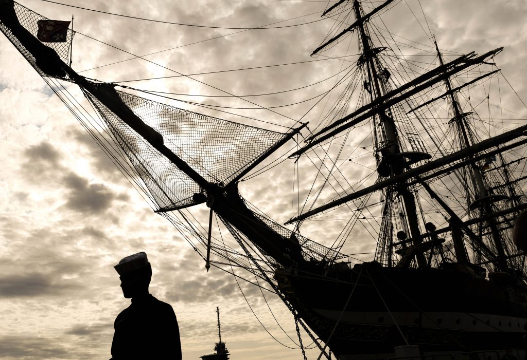 epa07767843 A sailor passes by Italian Amerigo Vespucci tall ship during the Hanse sail maritime festival, Rostock-Warnemuende, Germany, 08 August 2019.  EPA-EFE/FILIP SINGER