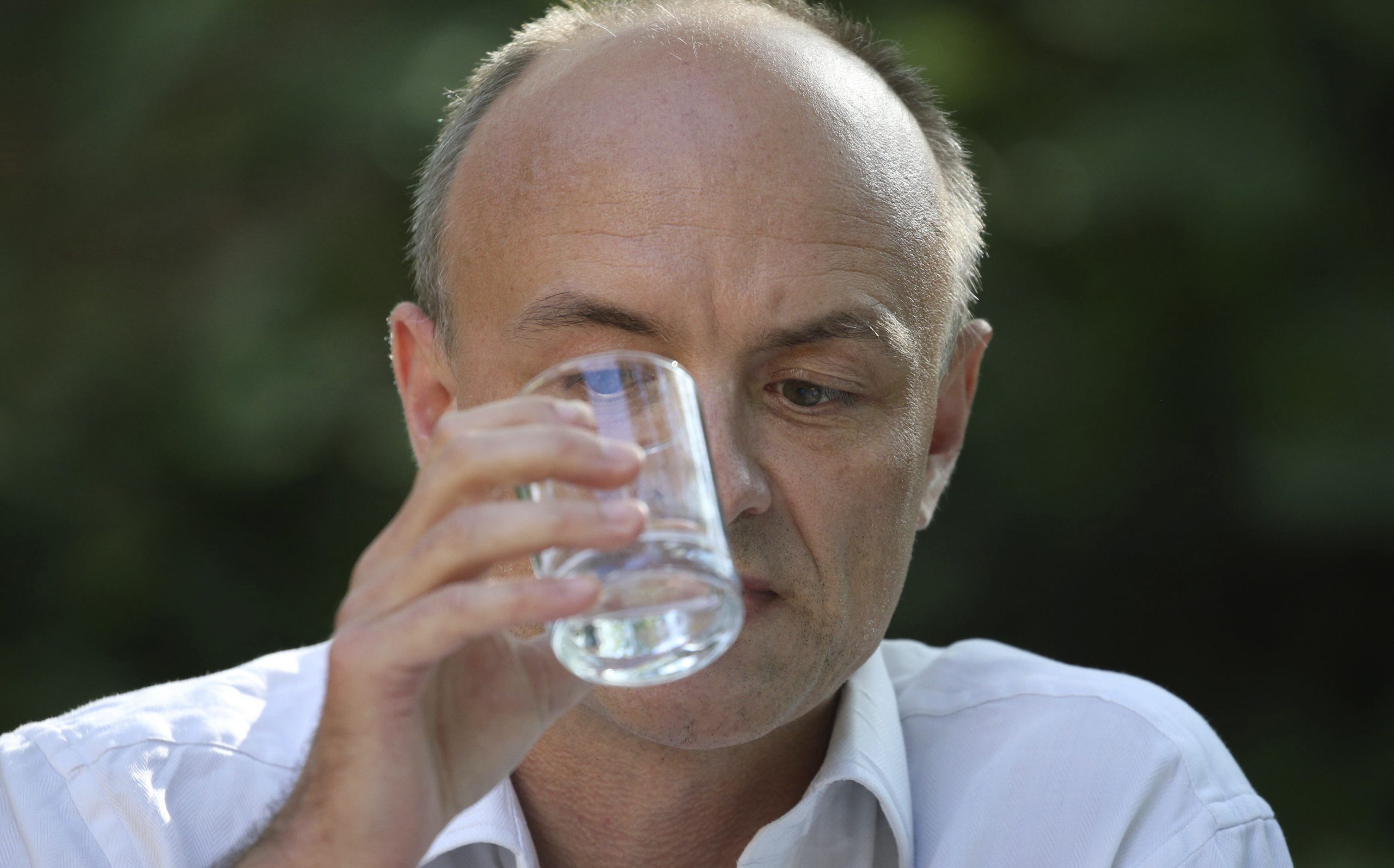 Dominic Cummings, senior aide to Prime Minister Boris Johnson, takes a drink as he makes a statement inside 10 Downing Street, London, Monday May 25, 2020, over allegations he breached coronavirus lockdown restrictions. (Jonathan Brady/Pool via AP)