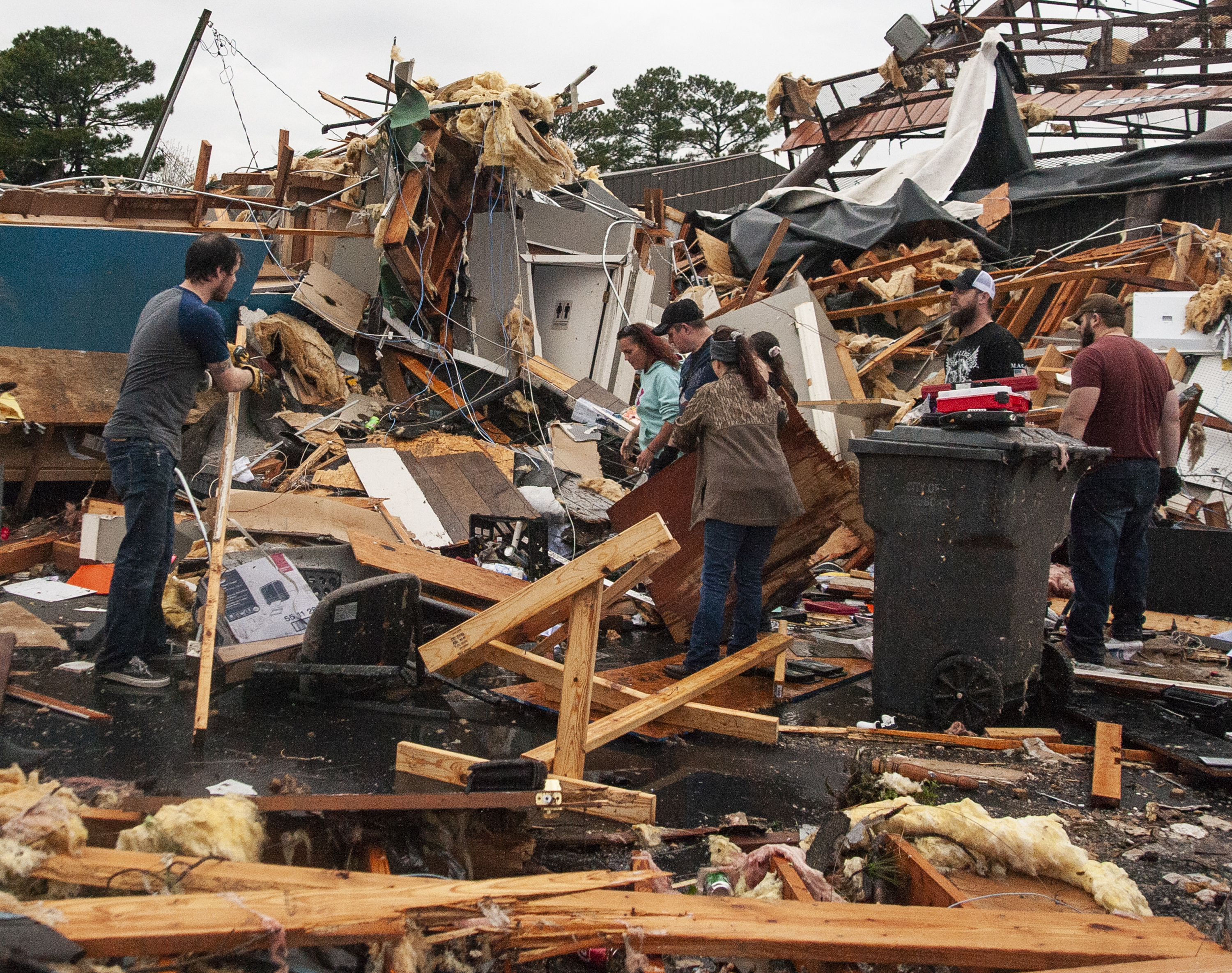 Arkanzas tornado A group of people help clear debris and salvage items from Pawn Depot after a tornado touched down Saturday, March 28, 2020, in Jonesboro, Ark. (Quentin Winstine/The Jonesboro Sun via AP)