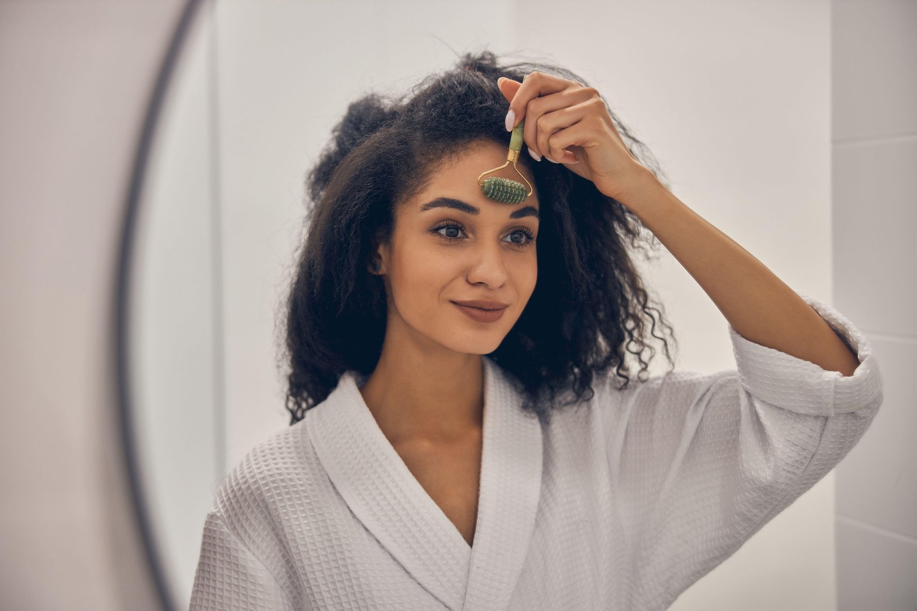 Portrait of a female in a waffle weave bathrobe massaging her forehead before the mirror,Image: 537876761, License: Royalty-free, Restrictions: , Model Release: yes, Credit line: Viacheslav Iakobchuk / Alamy / Alamy / Profimedia