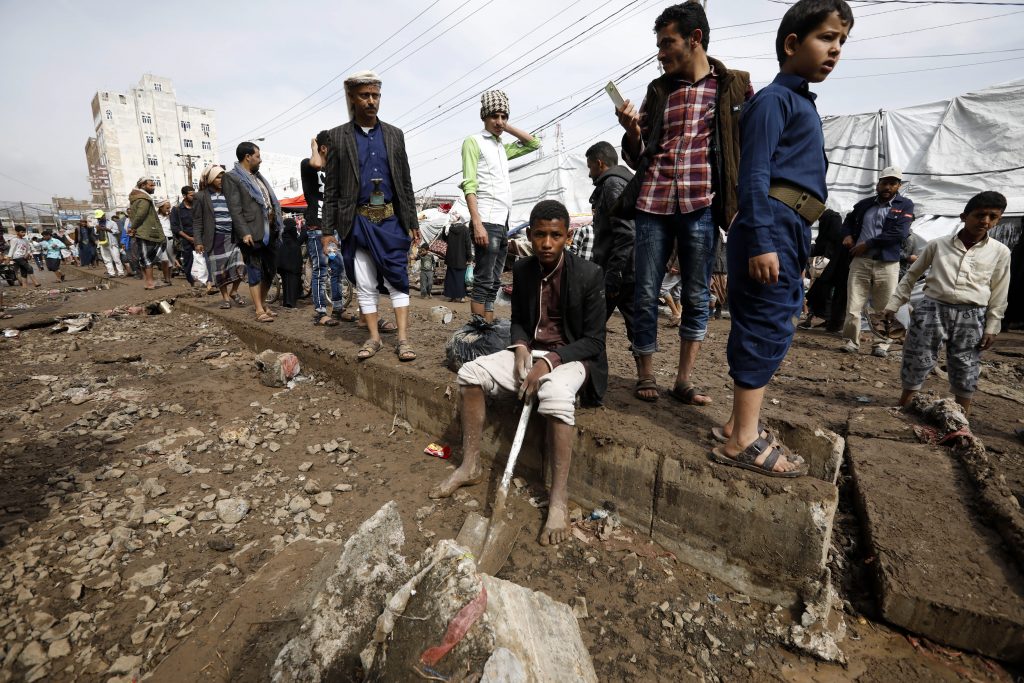 epa08362721 Yemenis walk through a damaged street following heavy rains in Sanaa, Yemen, 14 April 2020. According to reports, at least two Yemenis have been died in a flash flood triggered by heavy rains in the capital Sanaa.  EPA-EFE/YAHYA ARHAB